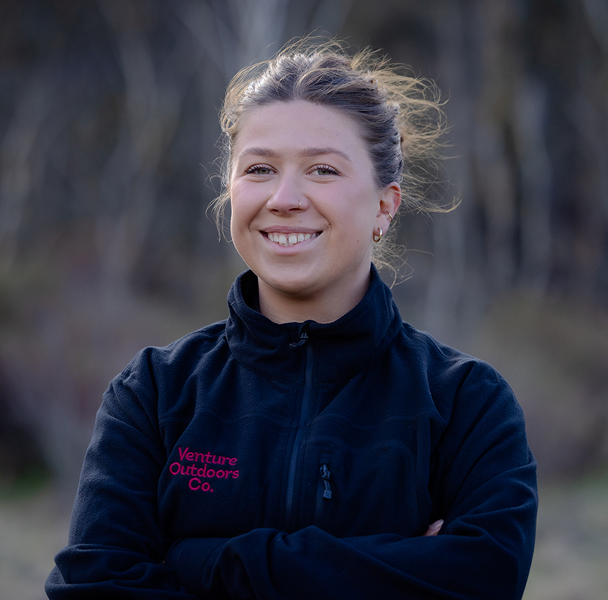 Portrait of Ellie Flanagan, Venture Outdoors Co. team member wearing uniform outdoors.