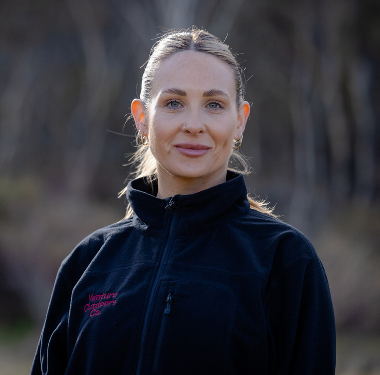 Portrait of Anni Cole, Venture Outdoors Co. team member wearing uniform outdoors.