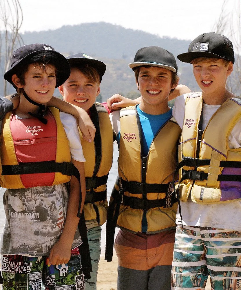 Group of students in PFDs and helmets during a Venture Outdoors Co. paddling program.