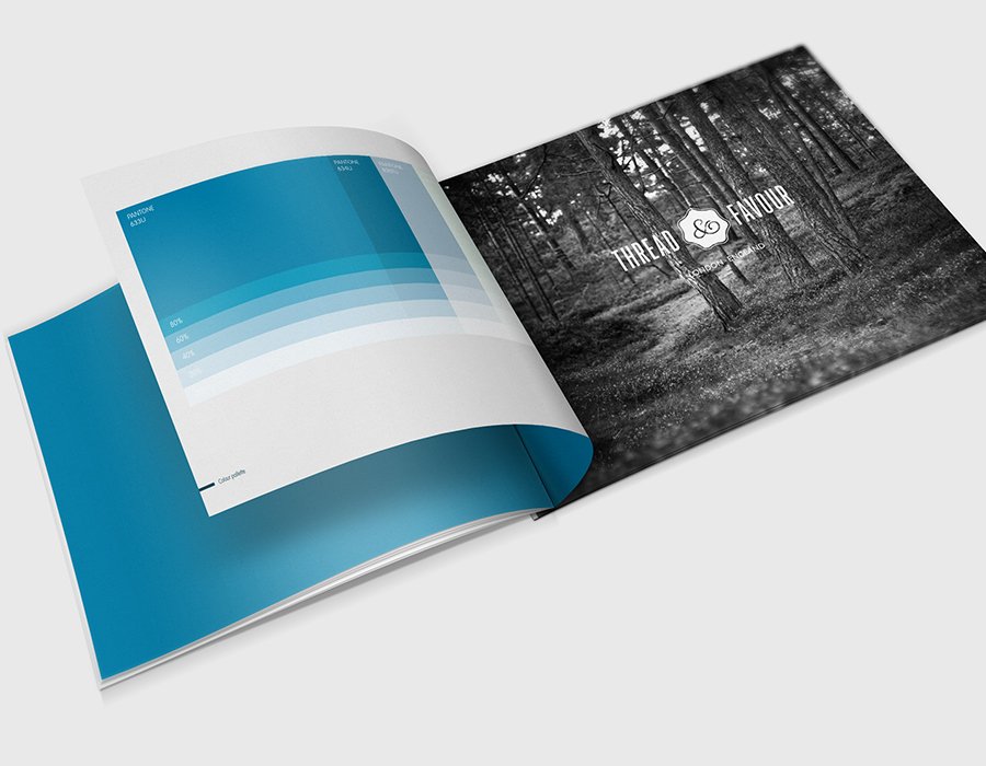 Open magazine showing a black-and-white forest scene on the right page and a blue and white infographic with percentage data on the left page.