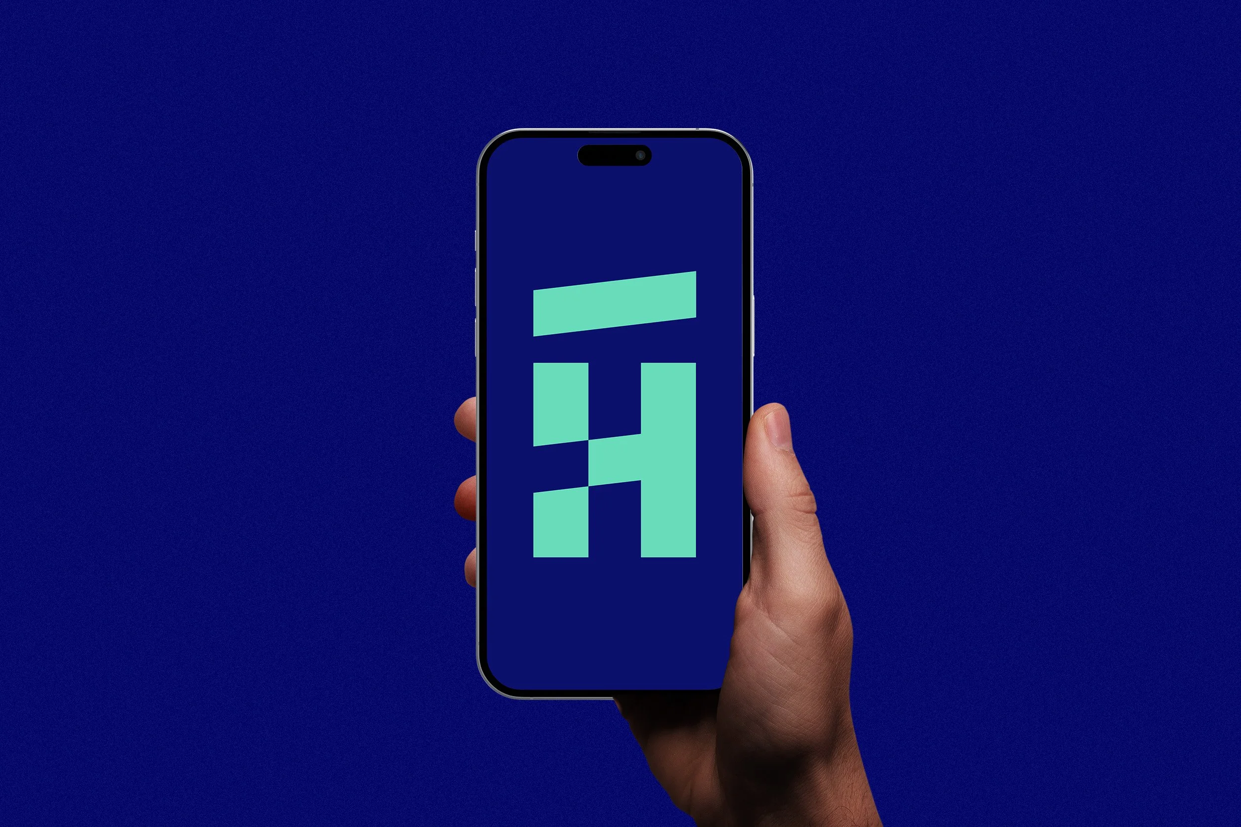 A hand holding a smartphone displaying a stylized logo on a dark blue background.