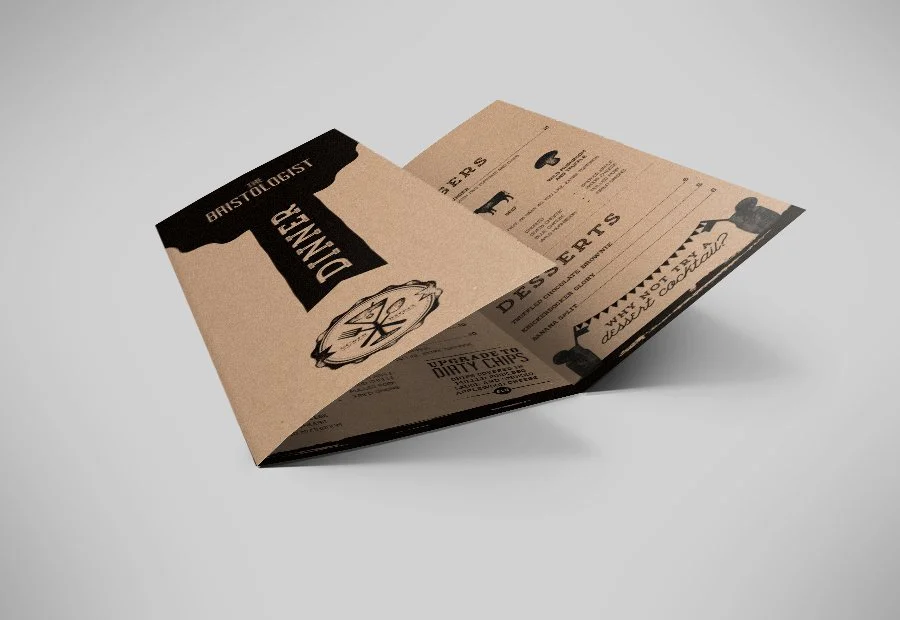 A folded paper menu with a rustic design from a restaurant called Bristol Oyster, featuring sections for dinner, drinks, and to-go options.