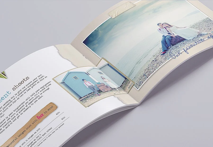 Open photo album displaying wedding photos on a white surface.