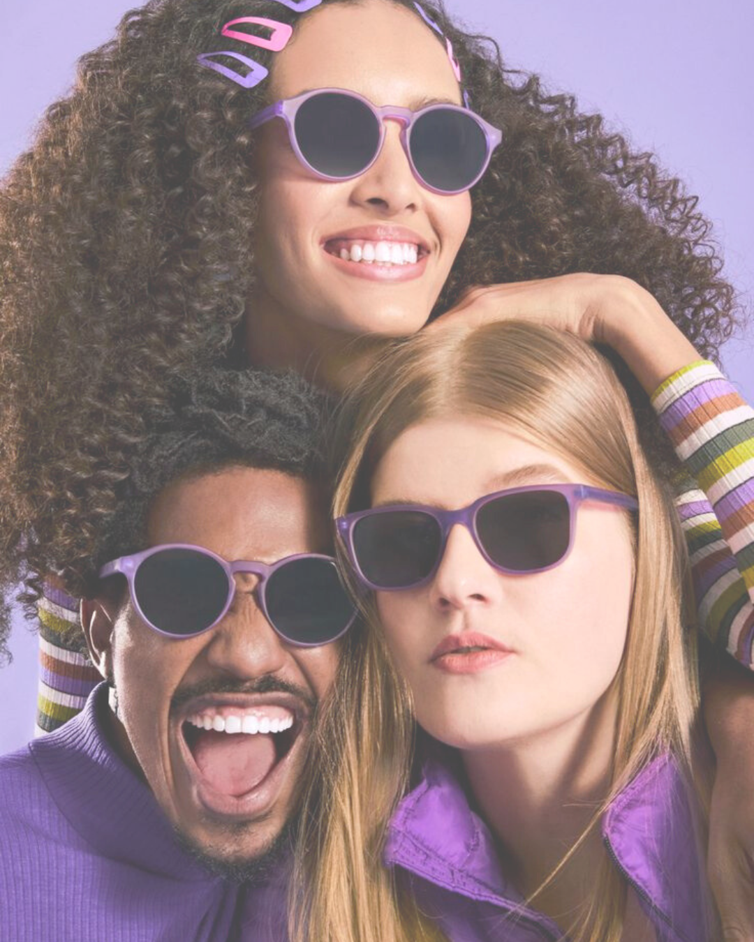 Three people with sunglasses on smiling and bright colours