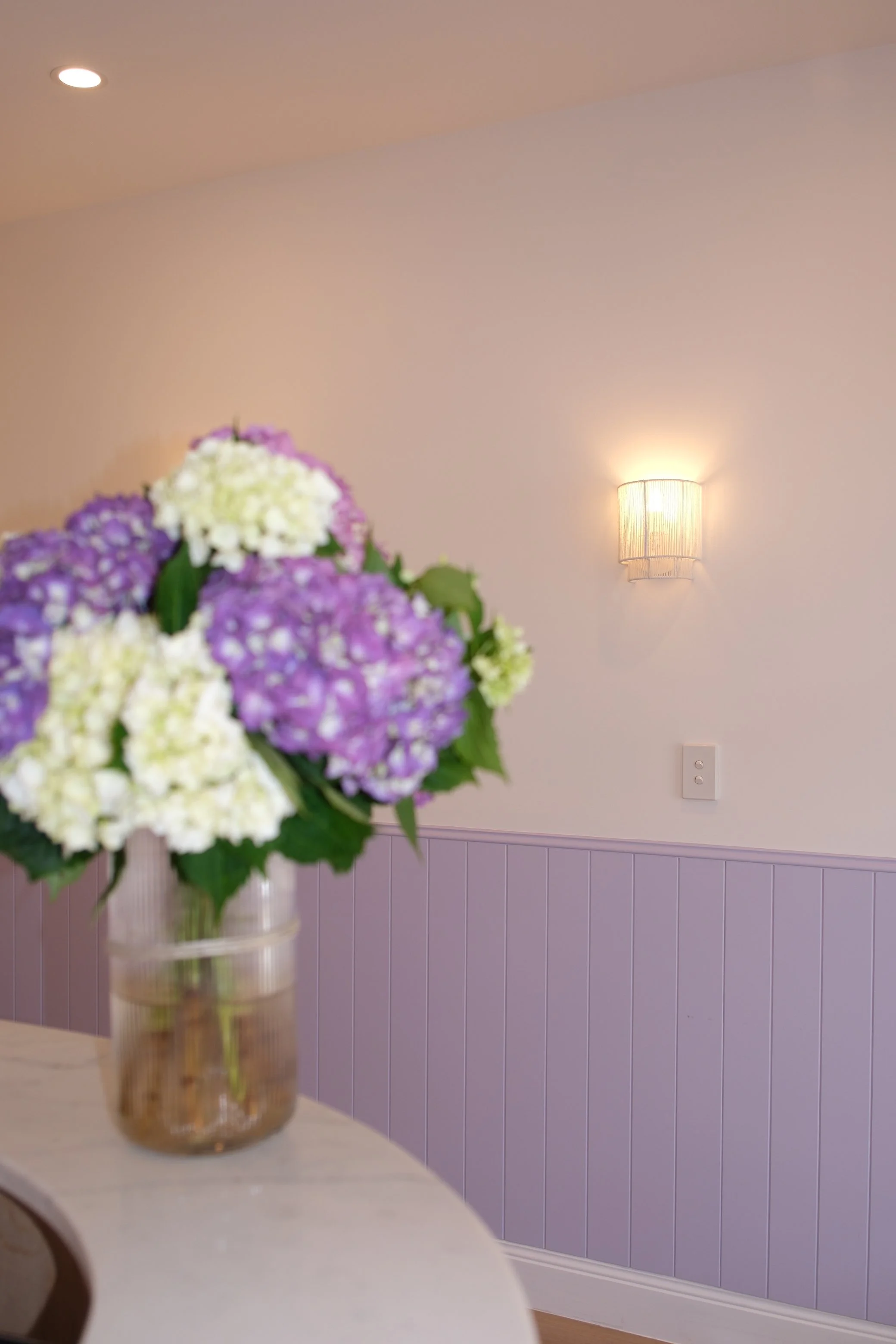 Storefront window for The Fit Injector Clinic with signage and a large poster of a woman.