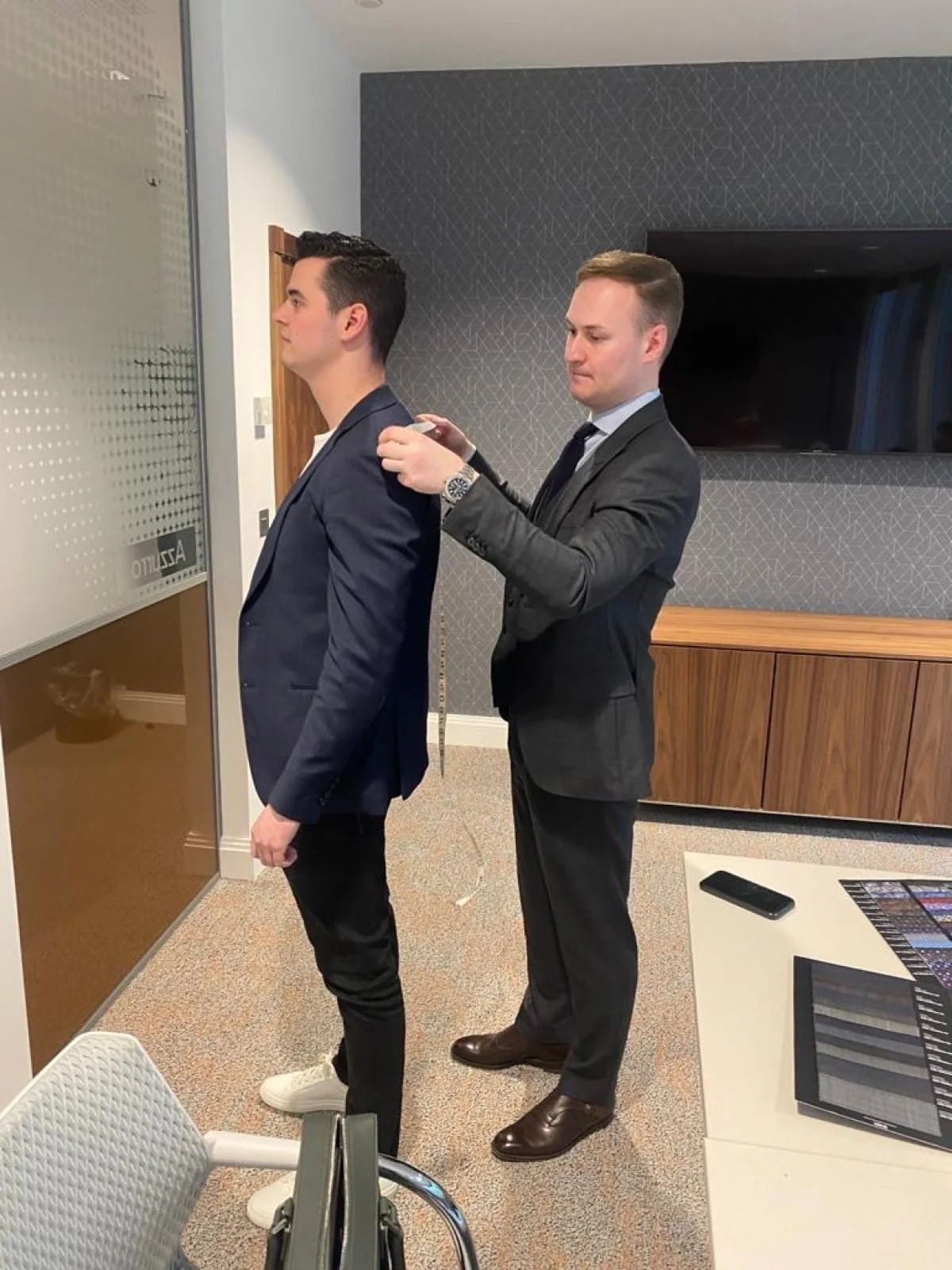 Amalfi Bespoke tailor Charles measuring an executive client for a suit jacket in his York offices