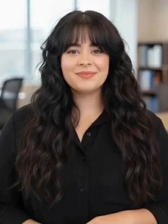 Andreina Rodriguez, Social Media and Community Manager at The Petzbe Agency, in a professional portrait with a softly blurred office background.