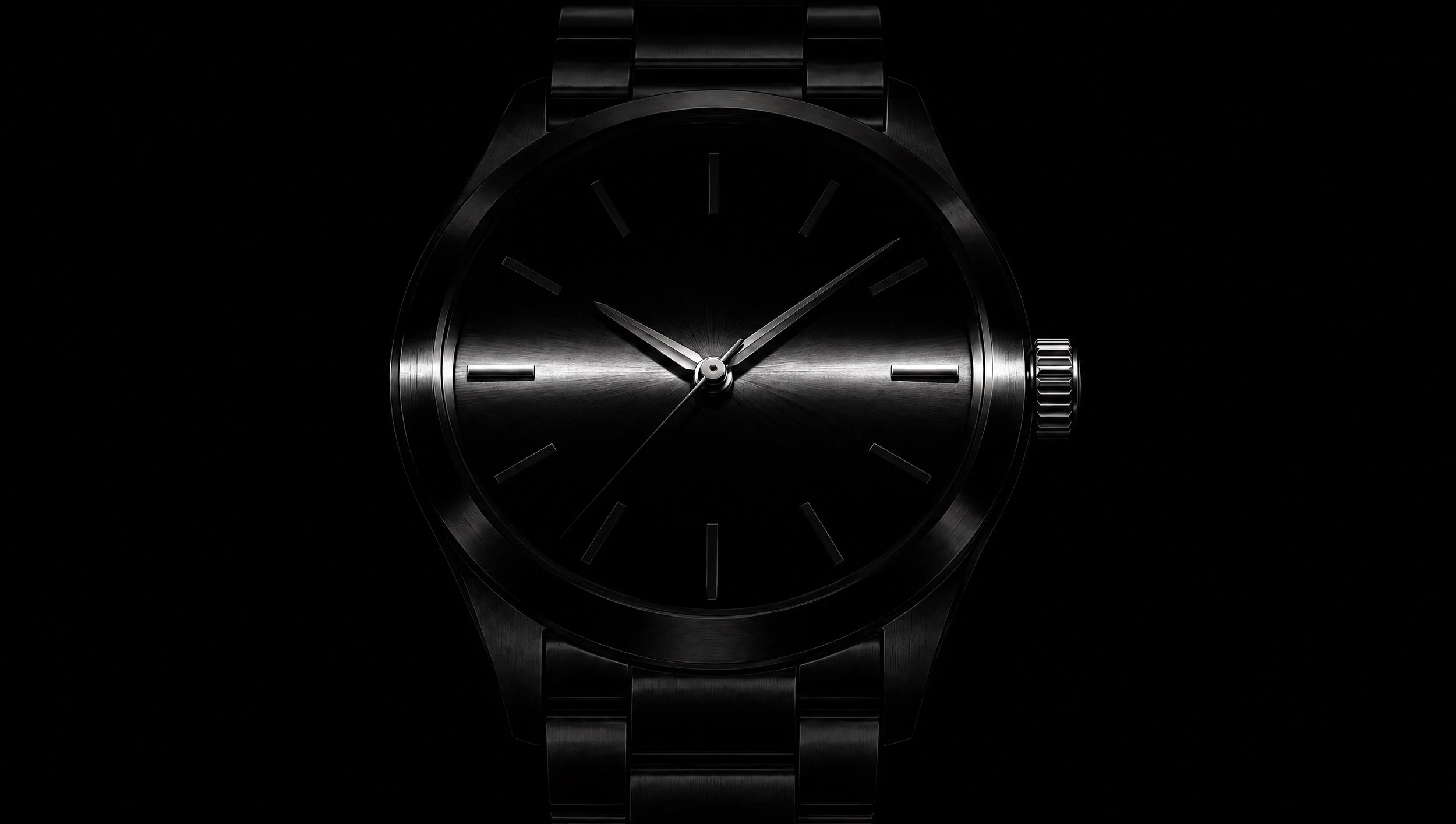 A black wristwatch caught by a thin blade of light.