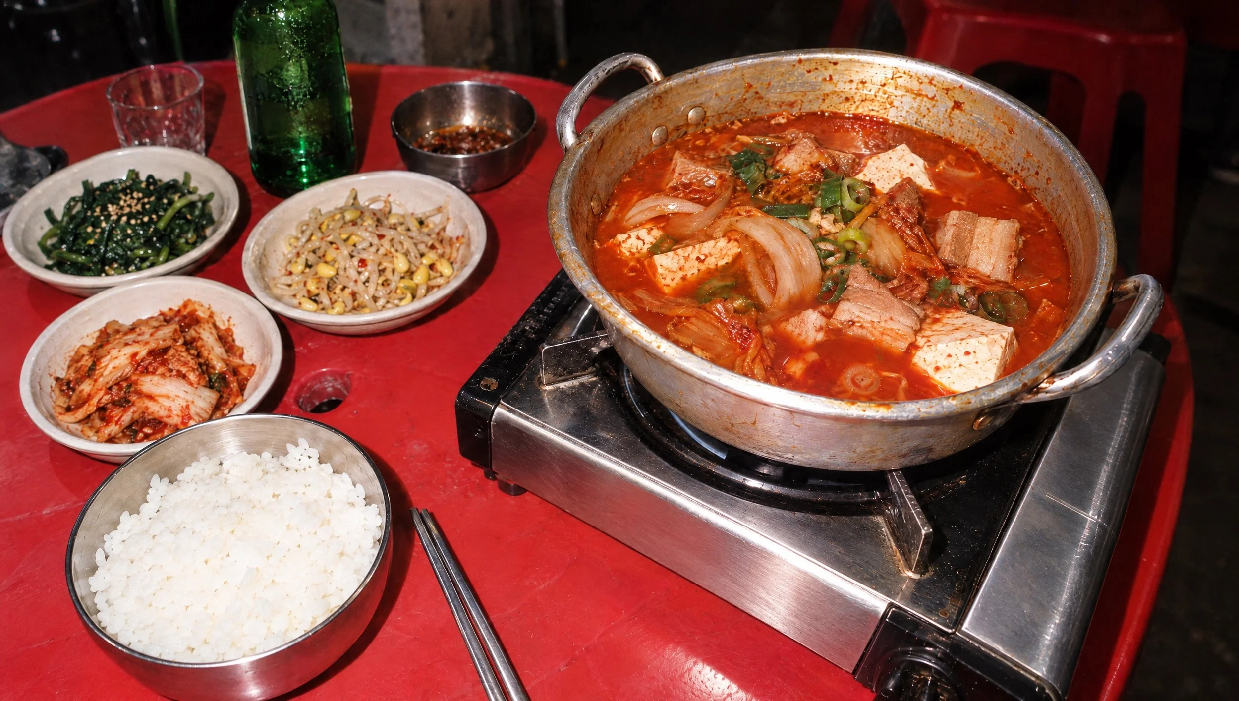 A bubbling pot of kimchi jjigae on a portable burner.