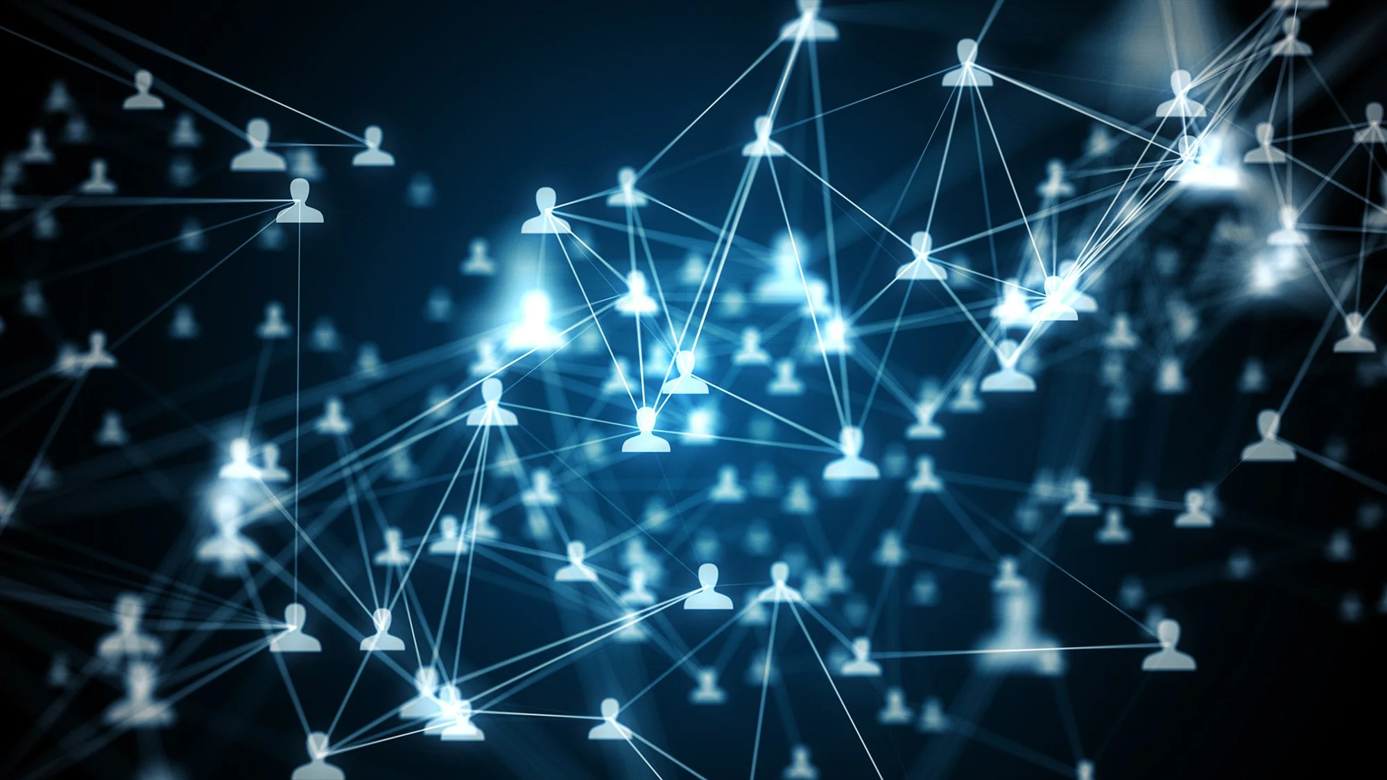 Digital network with interconnected glowing icons of people on a dark background.