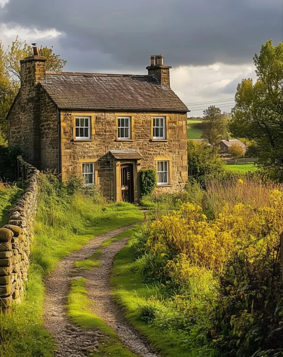 A stone house with a small front porch, four windows, and a chimney, situated along a dirt path with grass and yellow flowers, in a rural countryside setting with cloudy sky and rolling hills in the background.