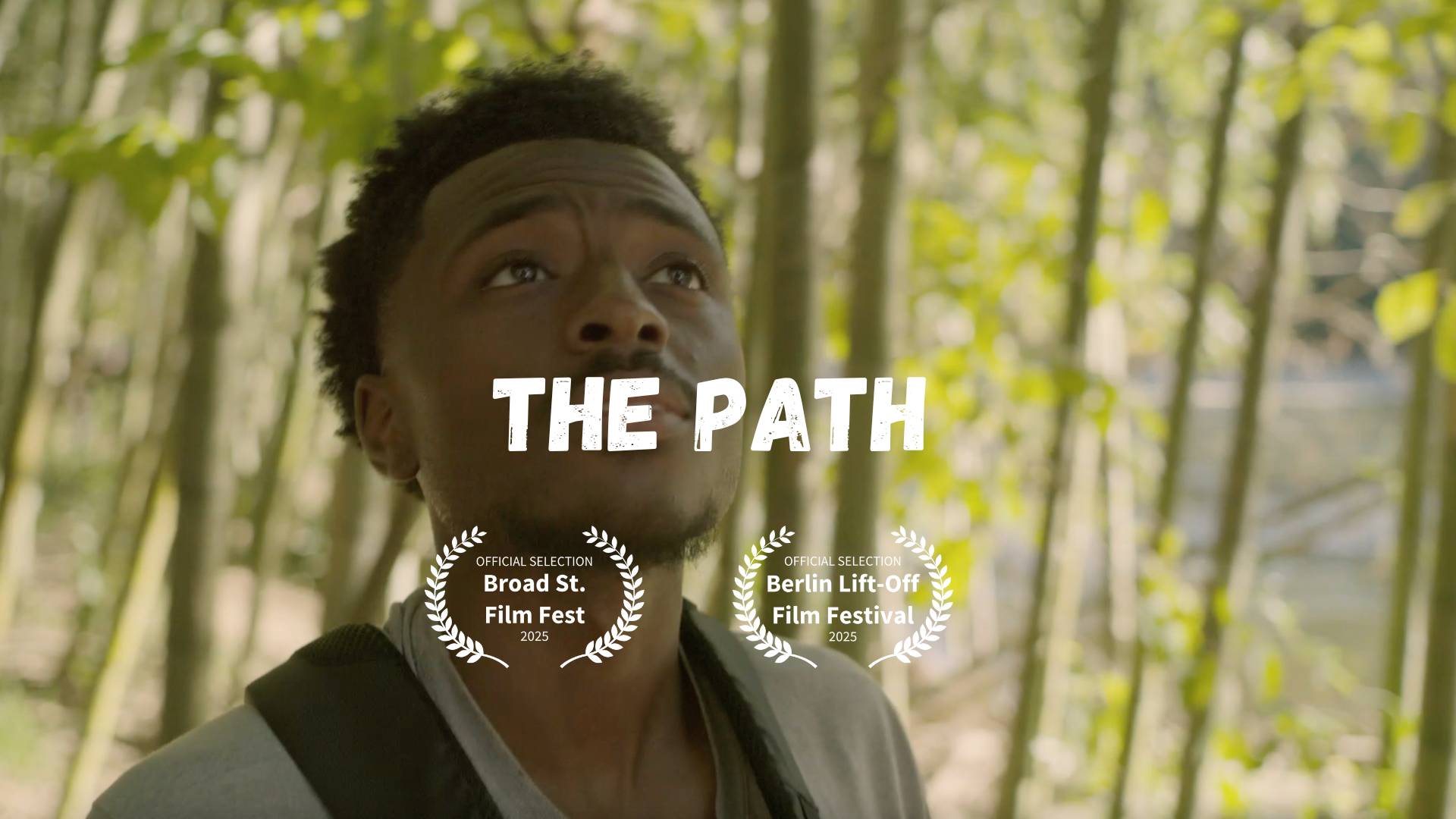 A young man with short curly hair and a backpack looking up in a wooded area with green leaves, with the title 'The Path' and two film festival selections overlaid.