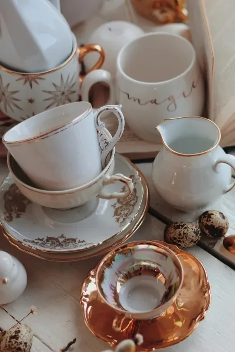 A collection of gold trim cups and saucers.