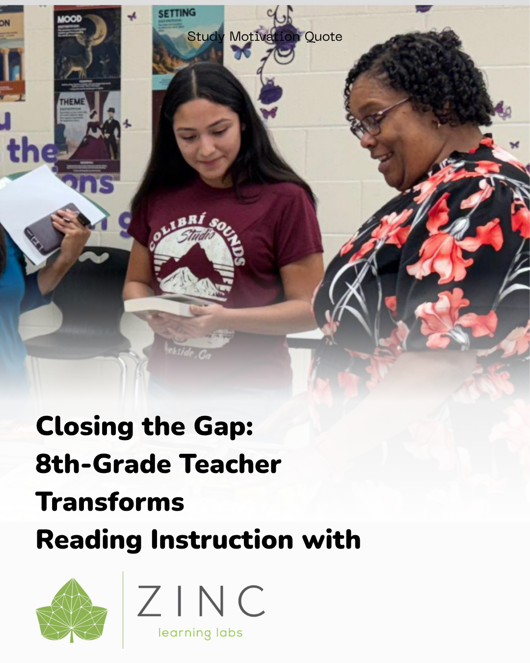 A teacher and a student in a classroom looking at a book together, with educational posters and decorations on the wall behind them.