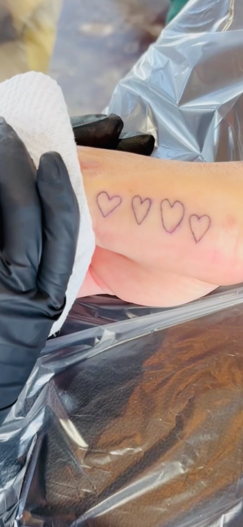 Such a heartfelt moment all her kids drew their own heart for her tattoo 