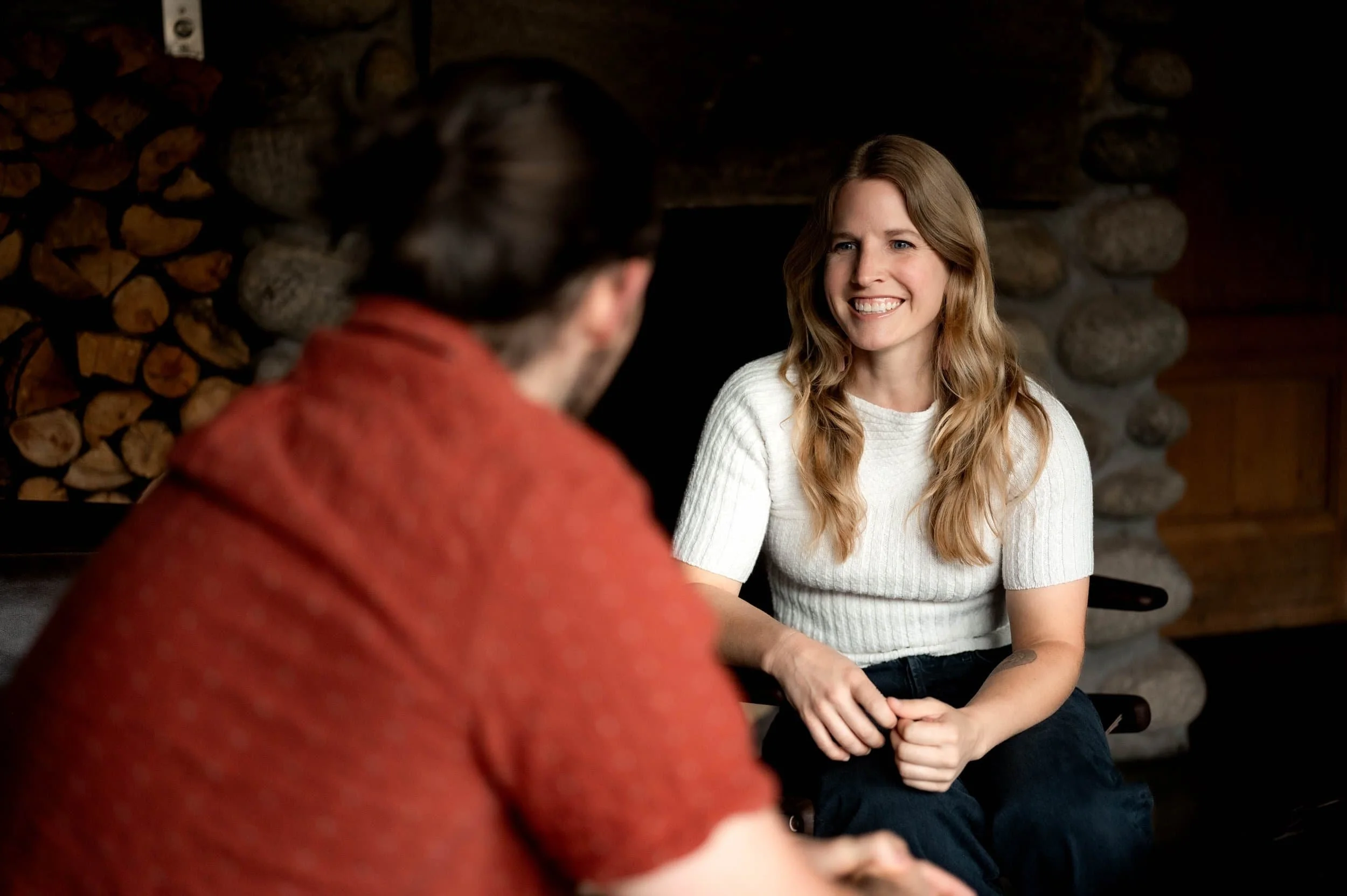 Life coach in Denver Colorado smiles while listening to a business man discuss improvements in his executive skills.