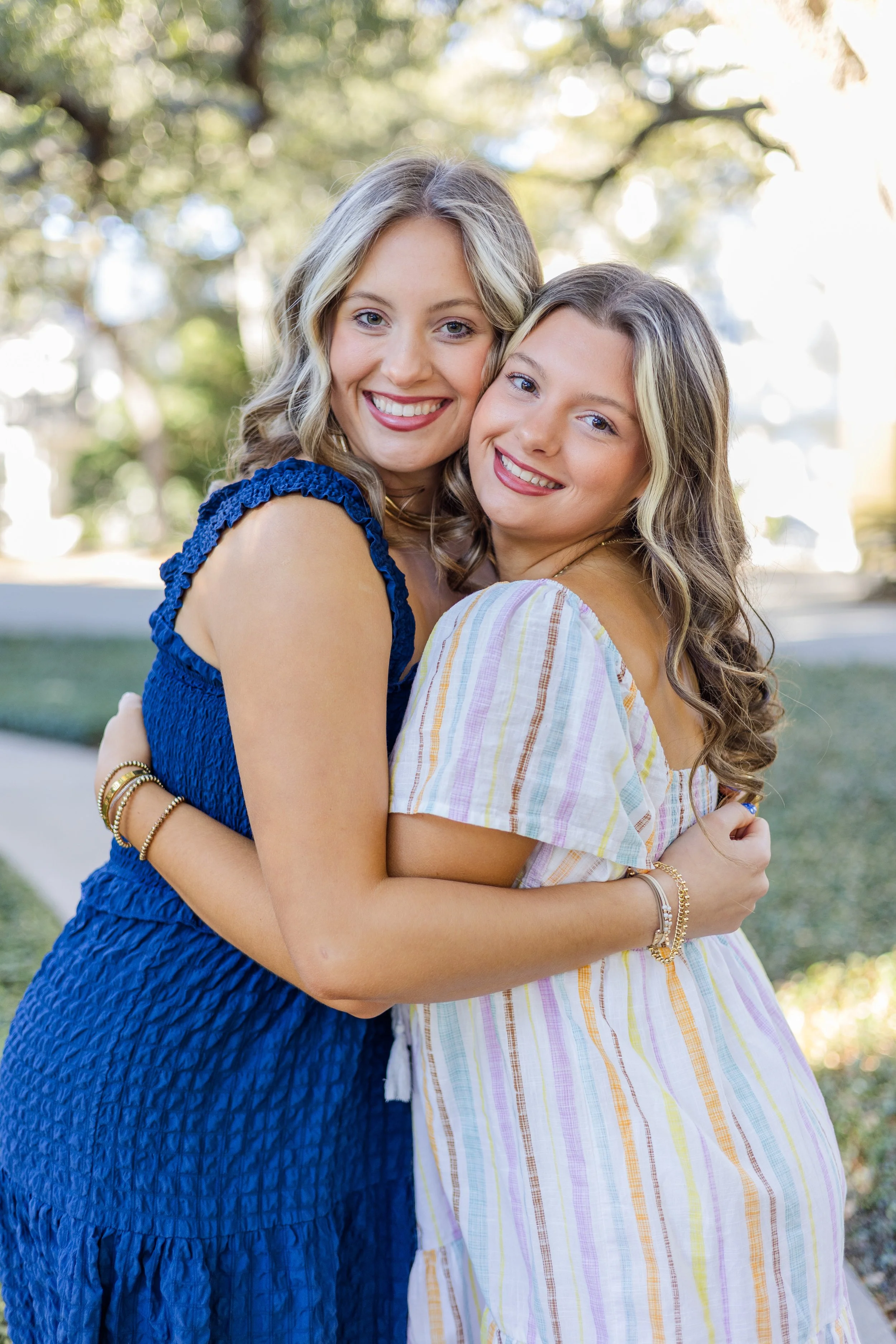 two senior sisters hugging each other on the island