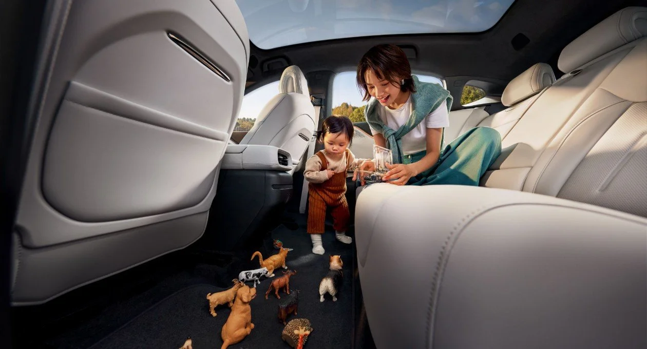Une femme et une petite fille jouent avec des jouets en forme d'animaux dans l'automobile