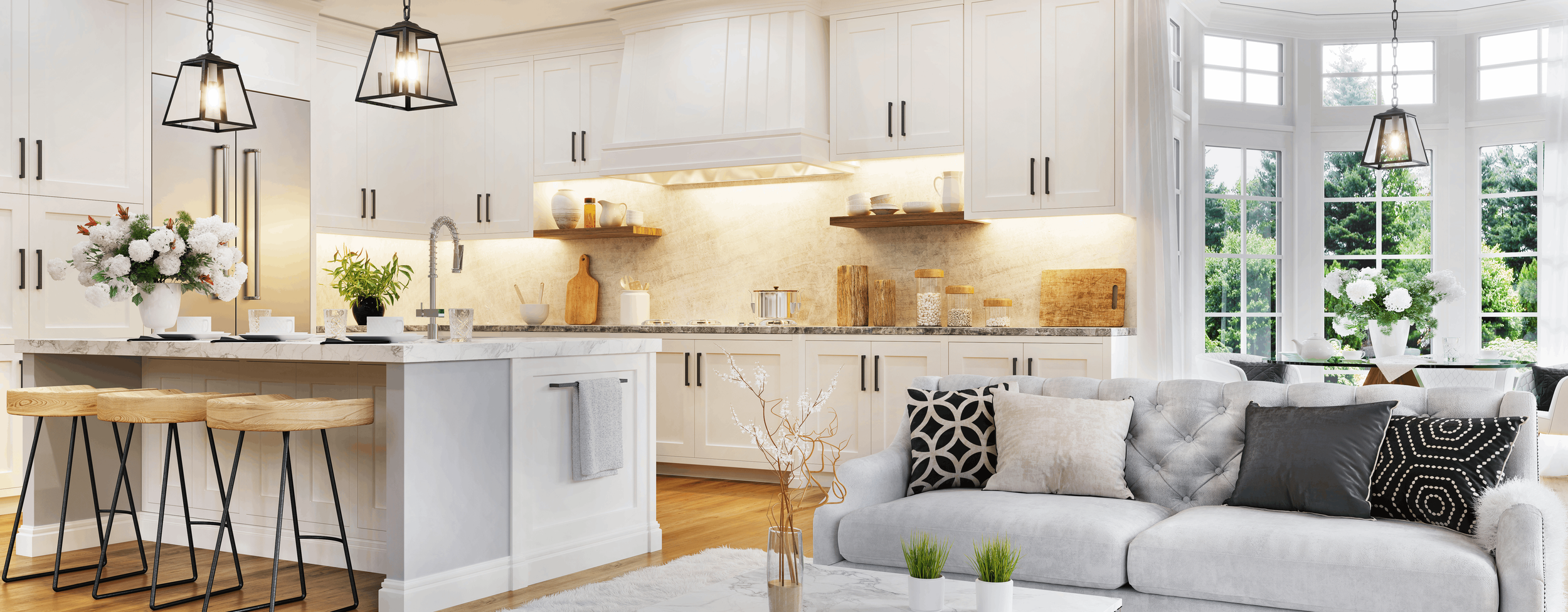 Bright, modern kitchen and living room with white cabinets, exposed shelving, and large windows with lush greenery outside. Decor includes flowers, cutting boards, and black-and-white pillows.