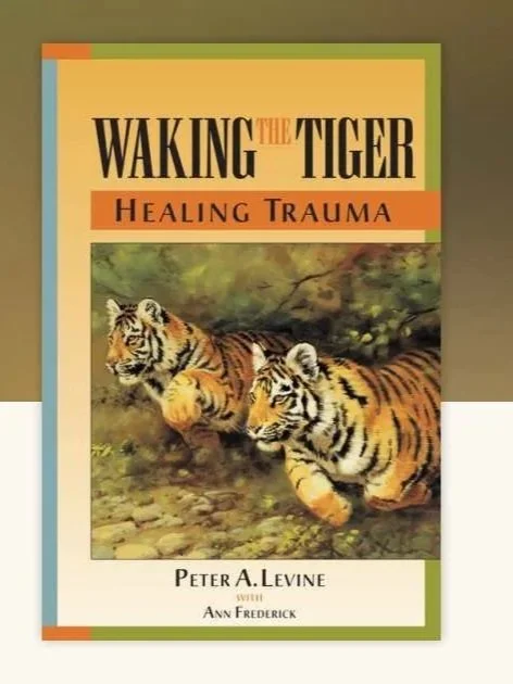 Book cover titled 'Waking the Tiger: Healing Trauma' by Peter A. Levine with Ann Frederick, featuring two tigers in a natural setting.