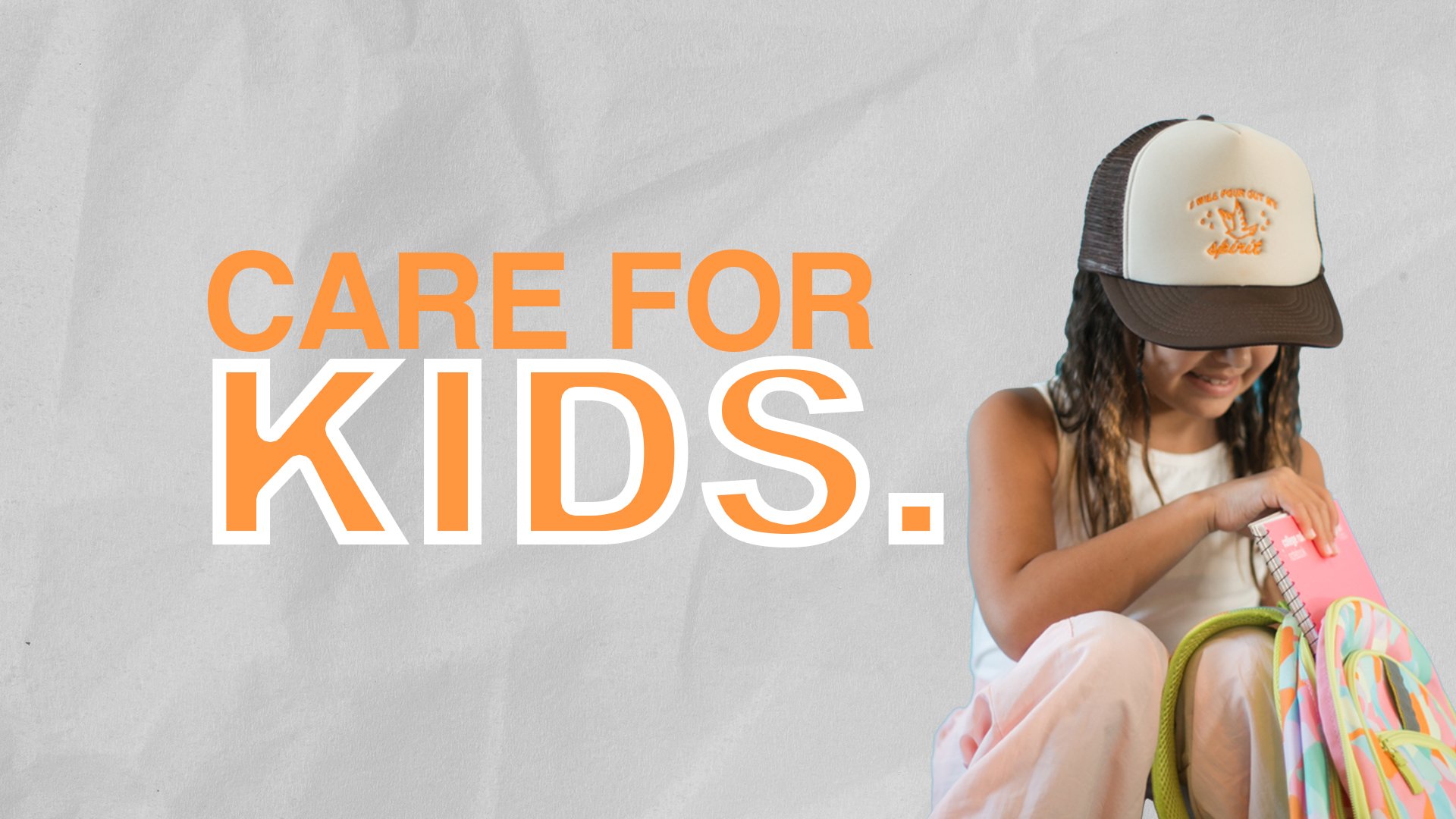 Young girl with curly hair wearing a trucker hat, sitting and smiling while opening a pink notebook from her colorful backpack, with the text 'Care for Kids' in bold orange and white letters on a gray background.