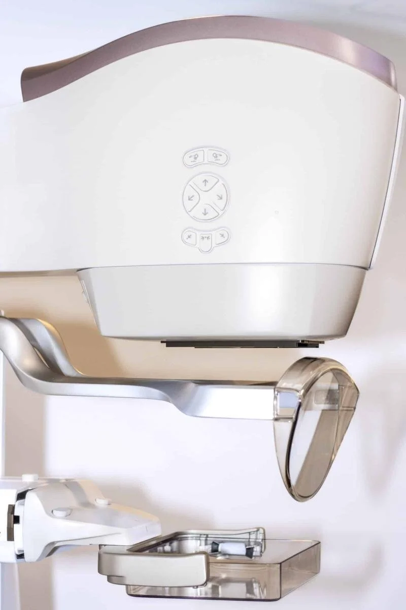 Medical imaging machine, possibly a dental or radiology X-ray device, with control buttons and a movable arm.