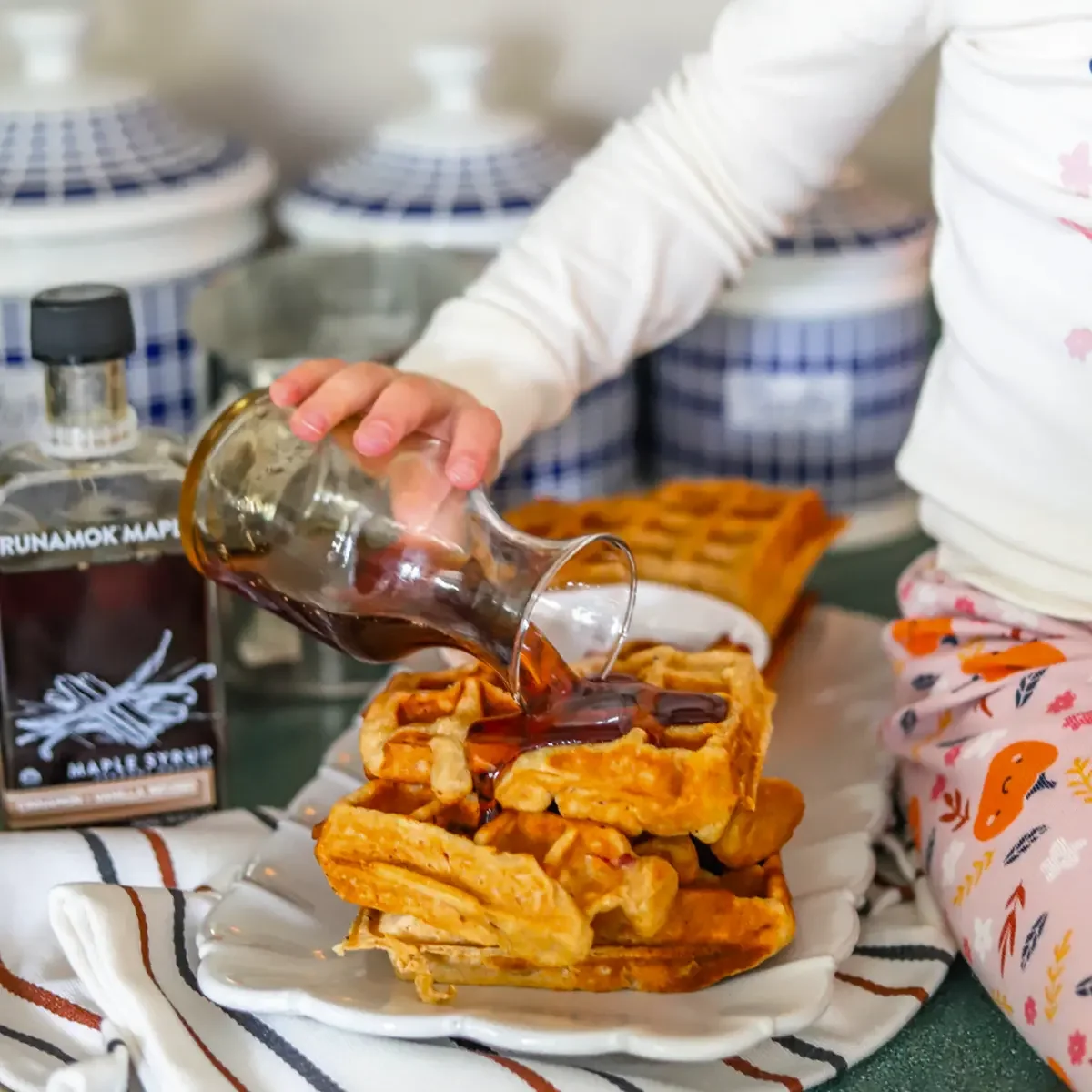 Waffles being drizzled with Runamok maple syrup