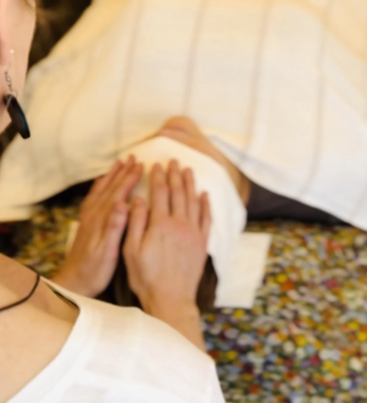 Close-up of a therapist holding someone's head