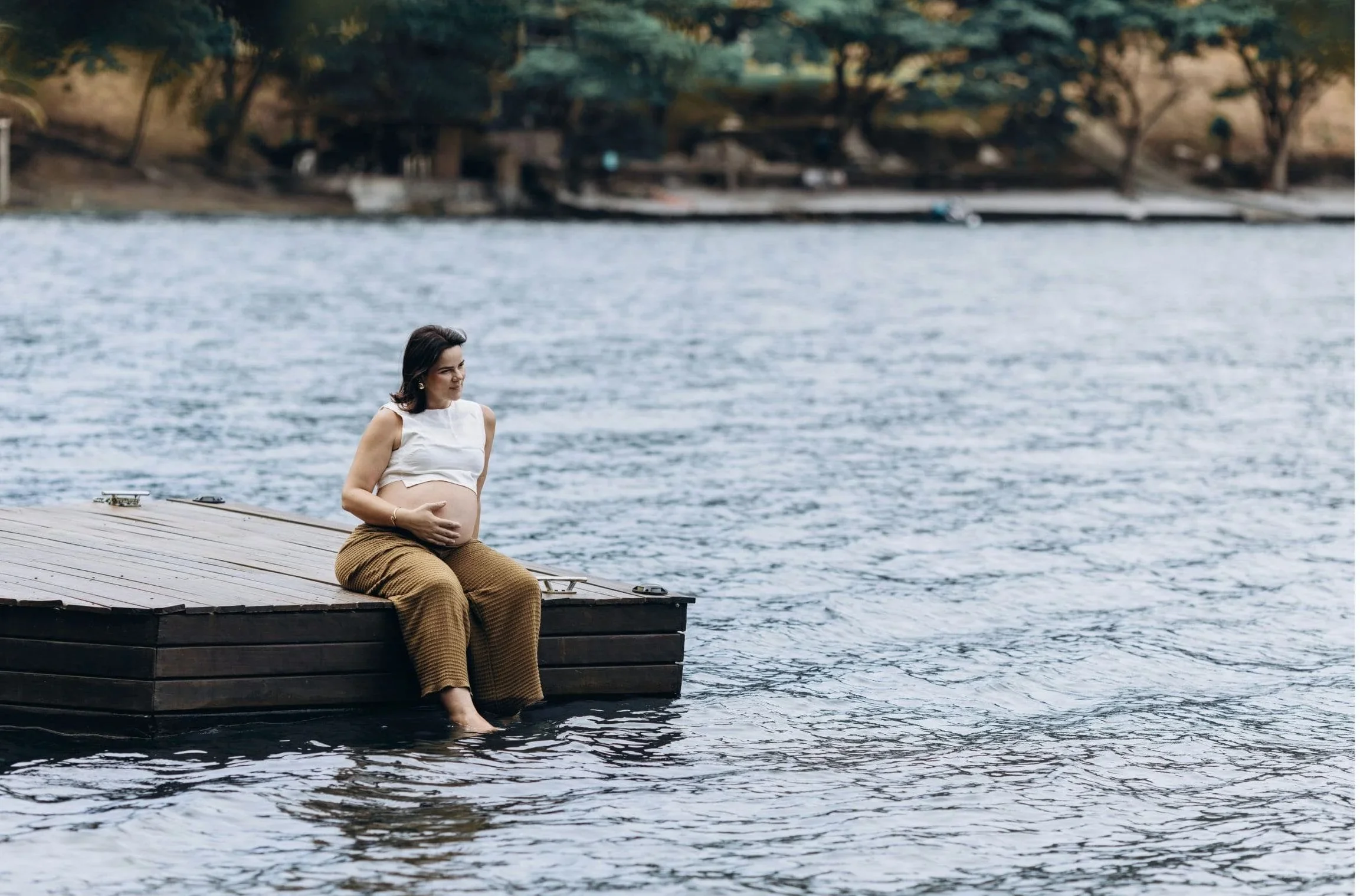 Postpartum therapy client sitting by the waterfront