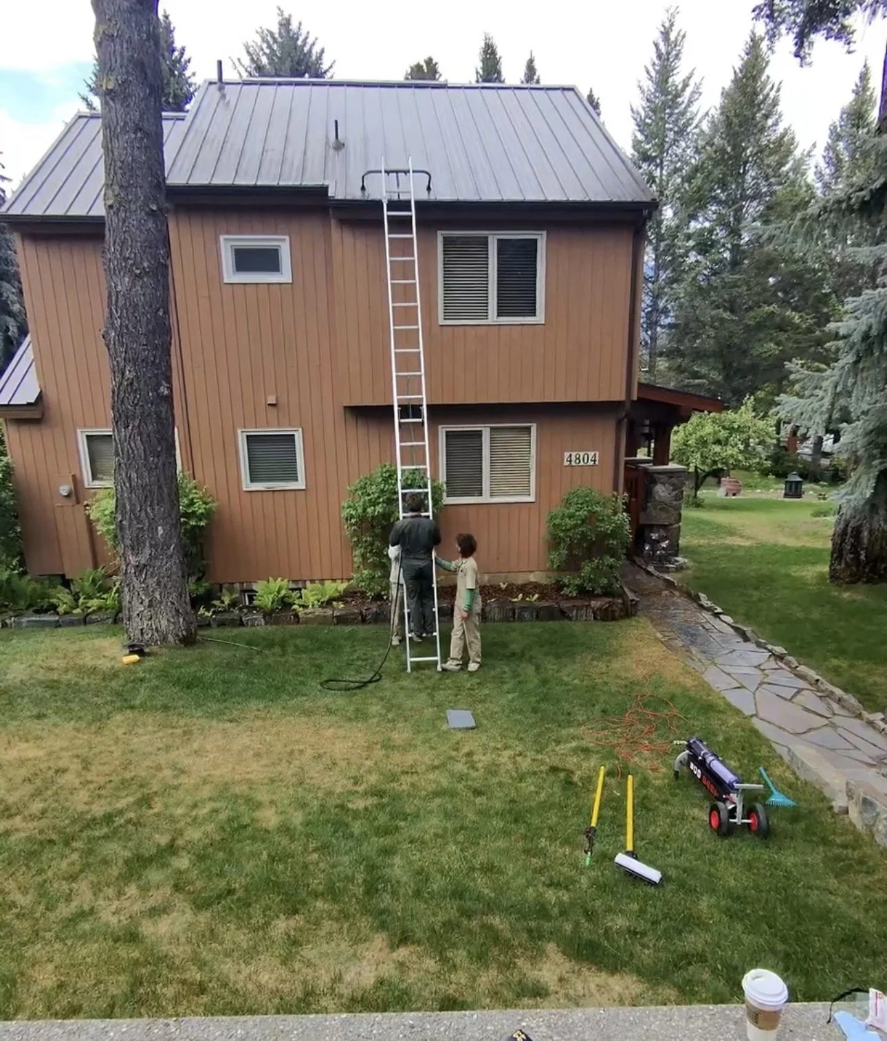 The Valley Shiners cleaning gutters in a home in windermere using safe ladder practices