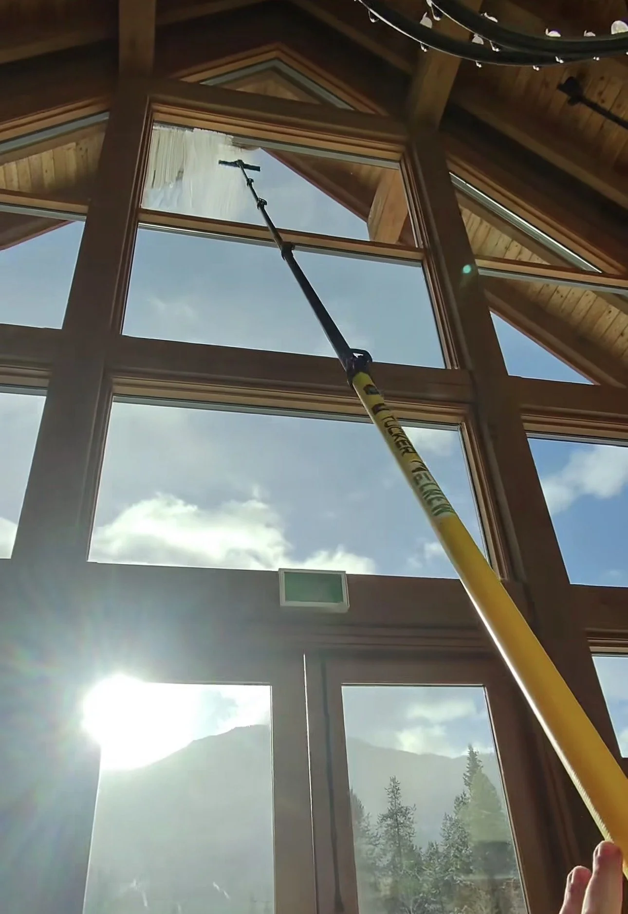 Window cleaning at a large A-frame home overlooking Greywolf Golf Course in Panorama BC by The Valley Shiners.