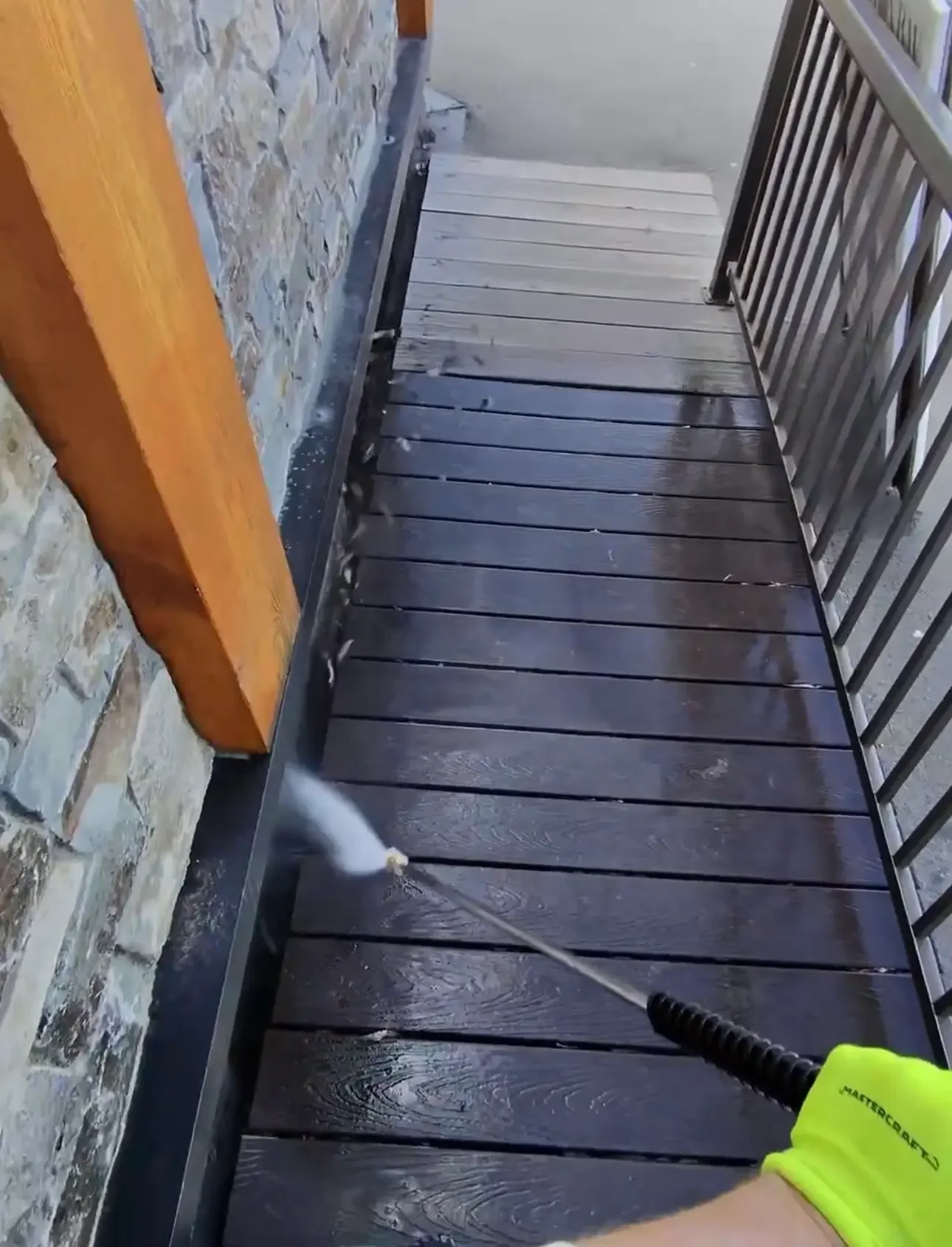Soft washing and pressure cleaning of a condo balcony and patio surface in the Columbia Valley as part of commercial exterior maintenance services.