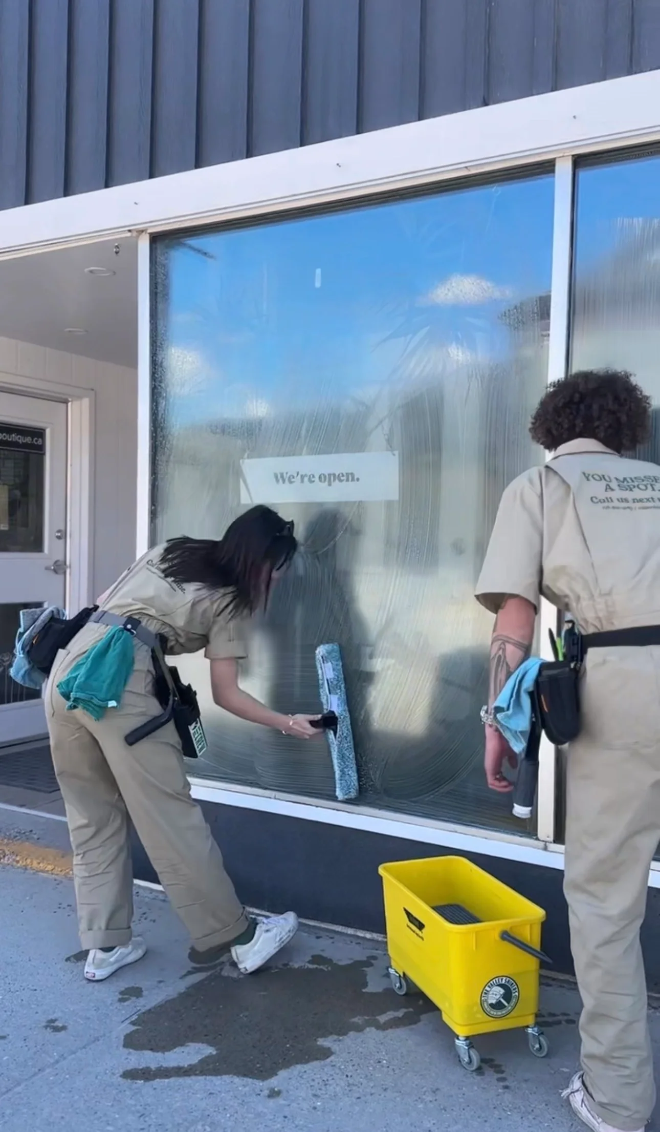 Valley Shiners crew cleaning a commercial storefront window in the Columbia Valley as part of professional retail and hospitality window cleaning services.
