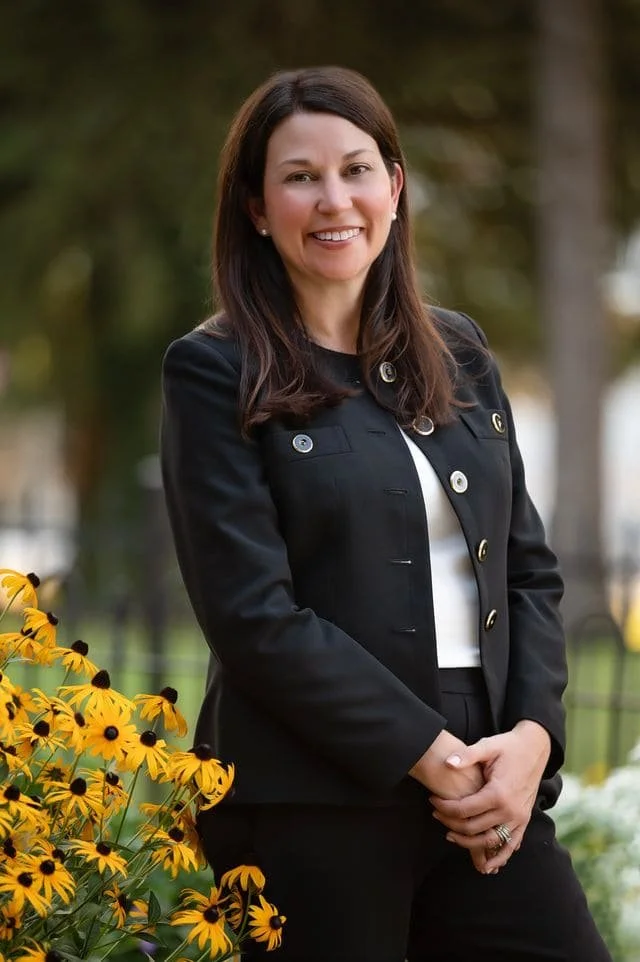 Michelle Wall, smiling, with a nature background