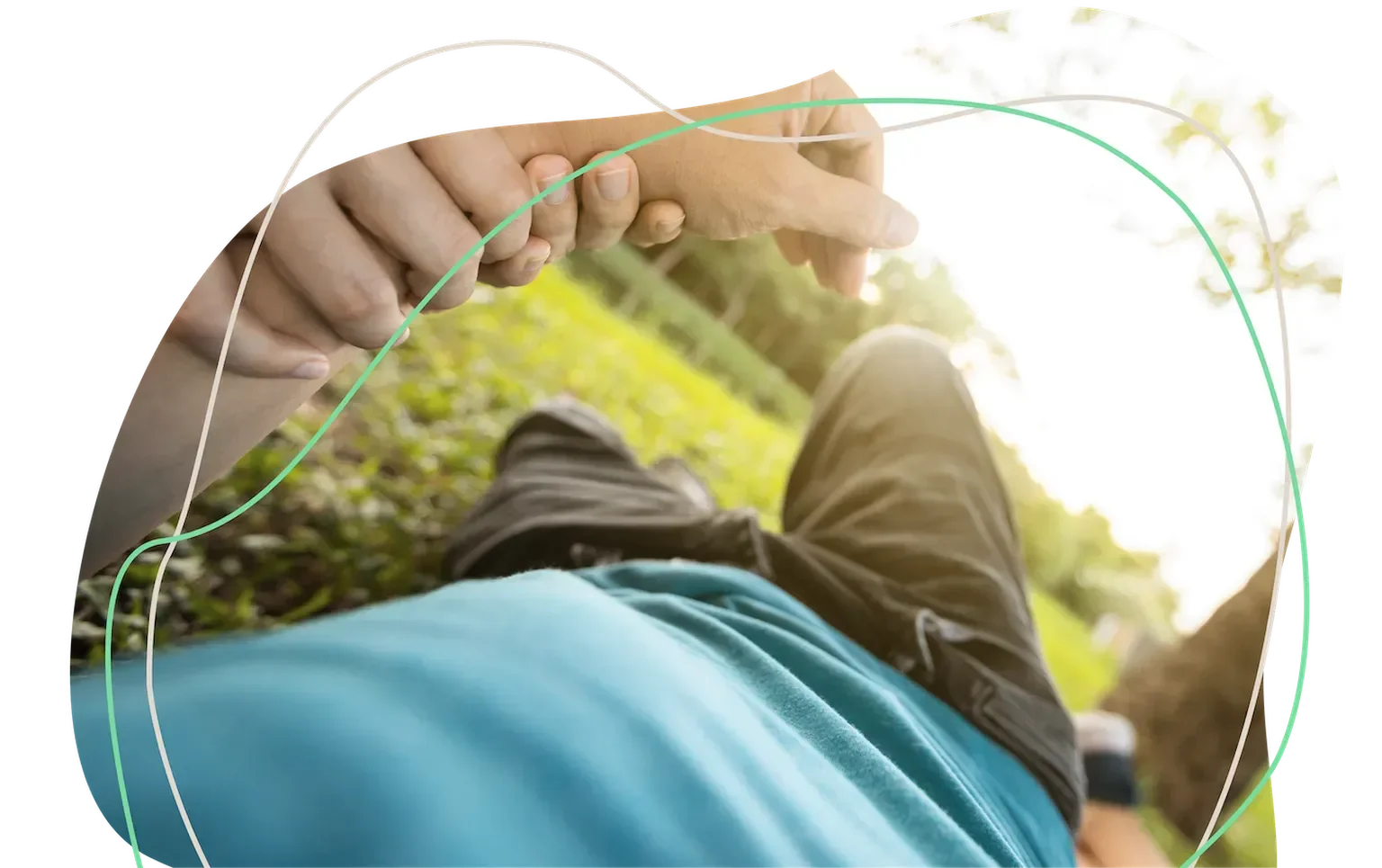 Person fainted on the grass while another individual checks their pulse, illustrating a syncope episode and emergency response