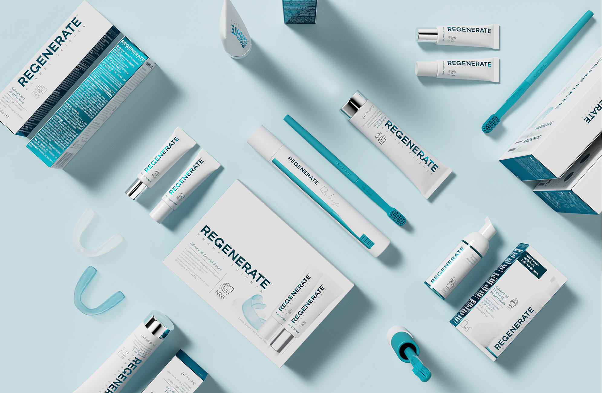 Composition of the Regenerate Enamel Science oral care range arranged diagonally, showcasing the unified turquoise identity.