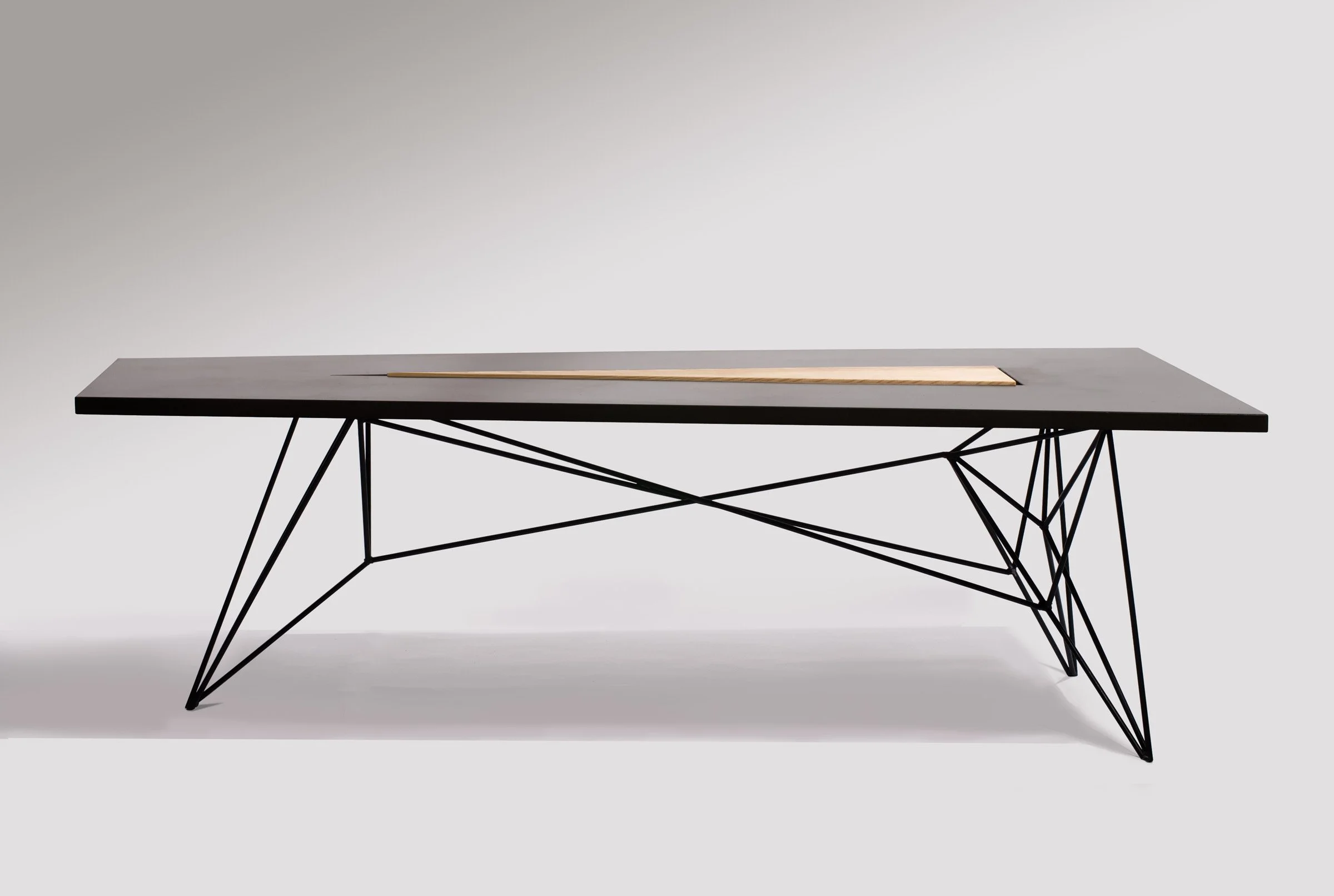 Custom handcrafted concrete, wood, and steel dining table built for New York’s Flatiron Building. Features raised wood centerpiece and modern steel base.