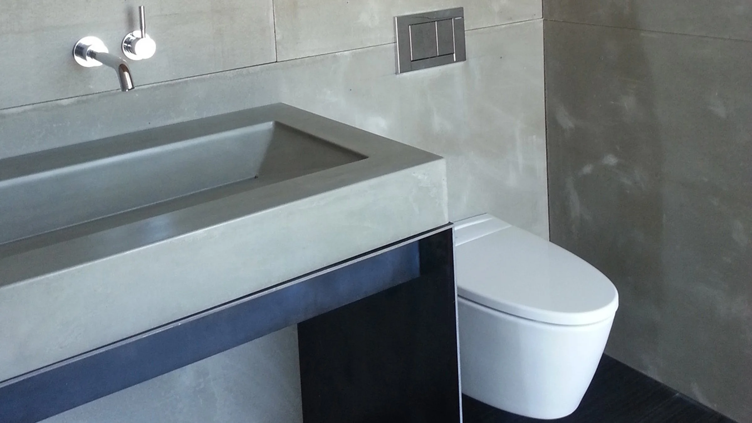 Custom Hard Goods ramp sink created for the ASU Solar Decathlon House. Handcrafted GFRC concrete sink with waxed steel base, made in the USA.