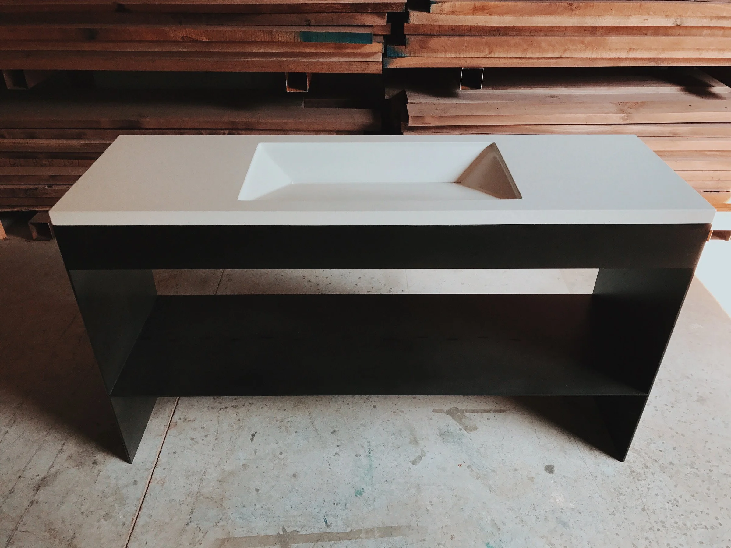 Lincoln Sink, a handcrafted GFRC concrete ramp sink with slot drain and steel base.