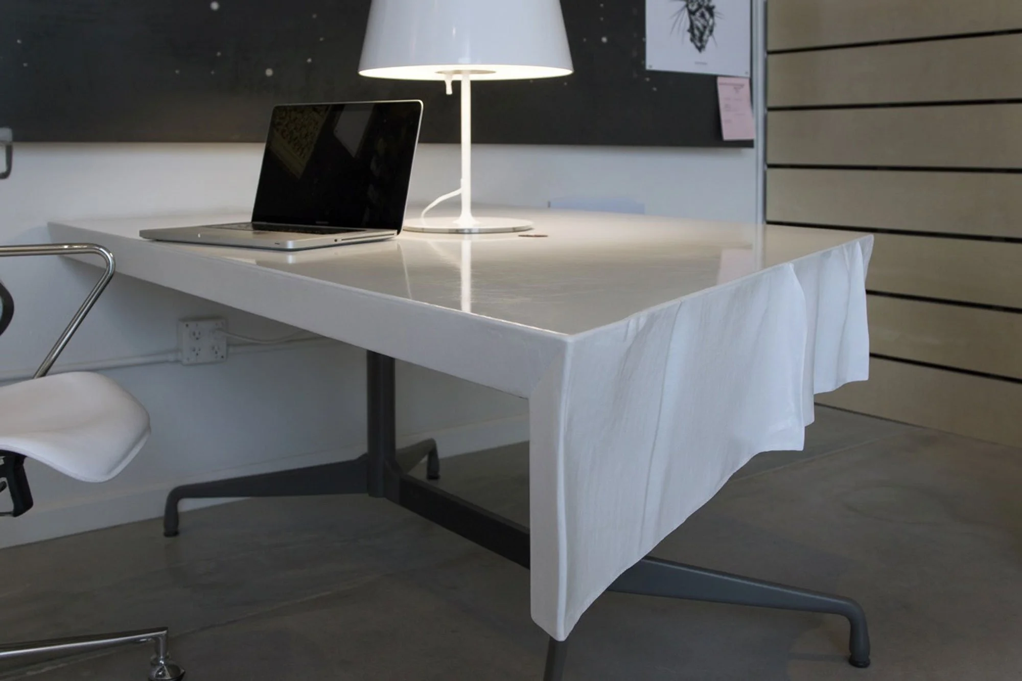 Custom concrete desk featuring copper grommets for cable management