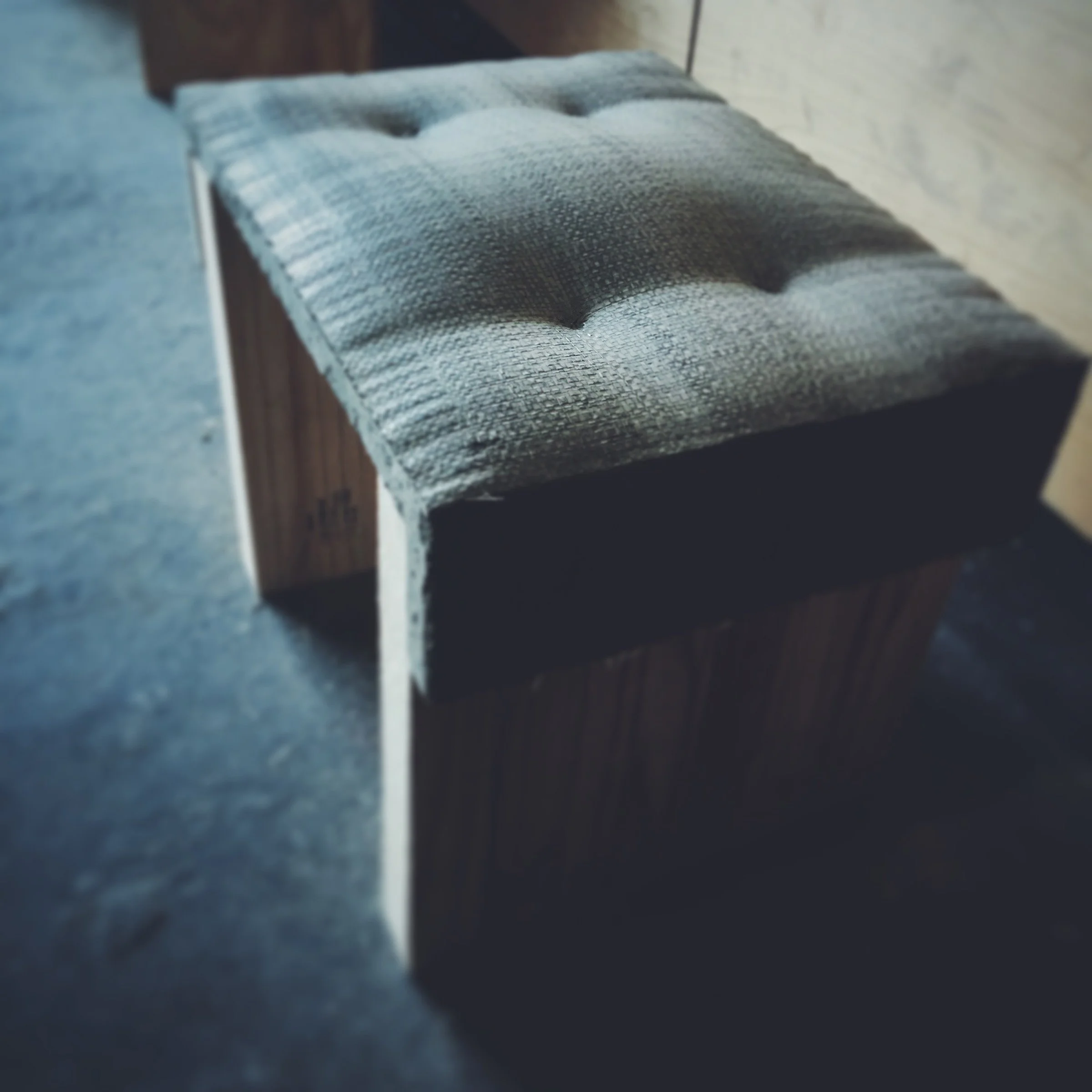 Fabric-formed concrete bench created in workshop setting. GFRC concrete with non-toxic sealer shows how design matters more than materials.