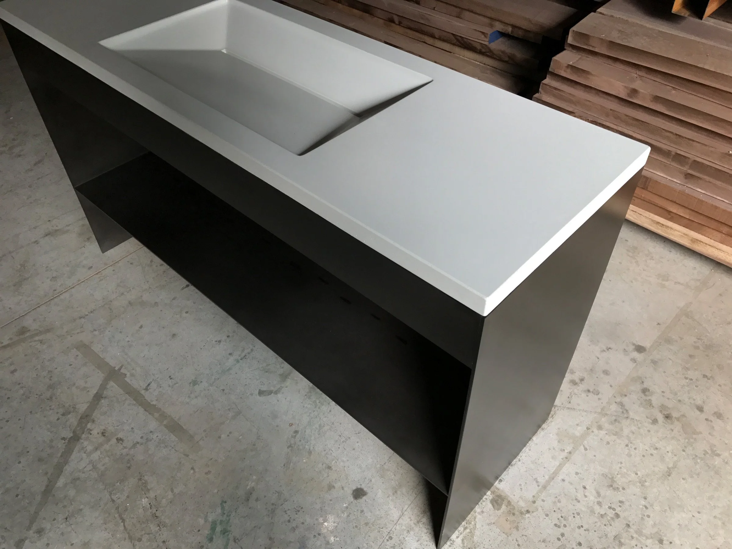 Modern concrete bathroom sink from the Hard Goods Collection with custom plate steel base.