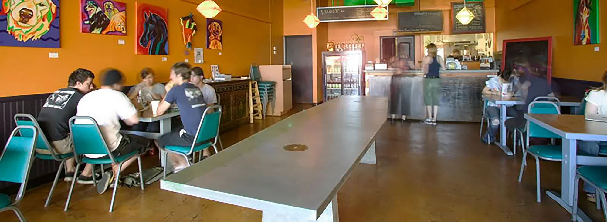 Concrete and wood dining table designed for restaurant interiors.