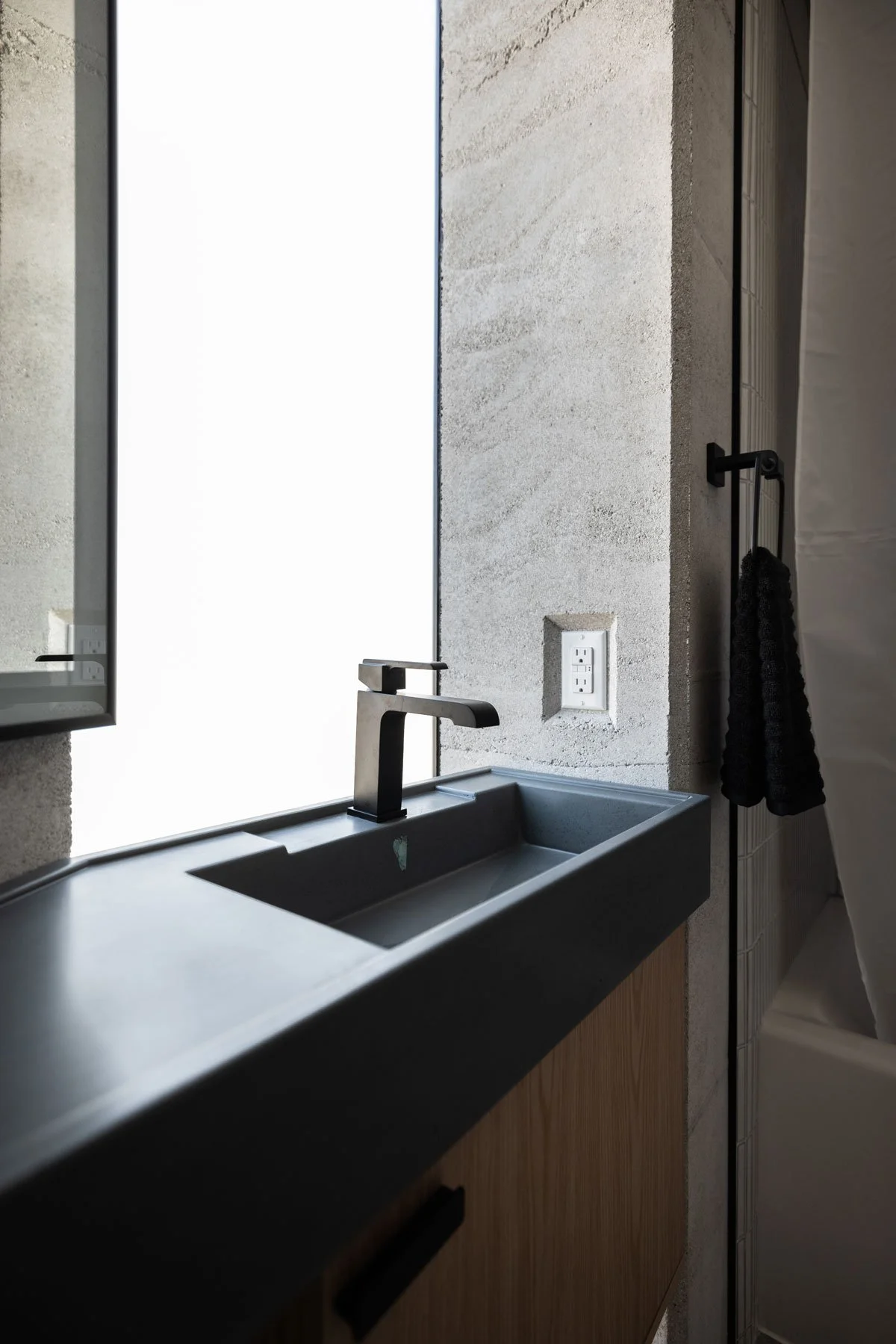 CALX Sinks designed to fit faceted rammed earth walls of the cabin.