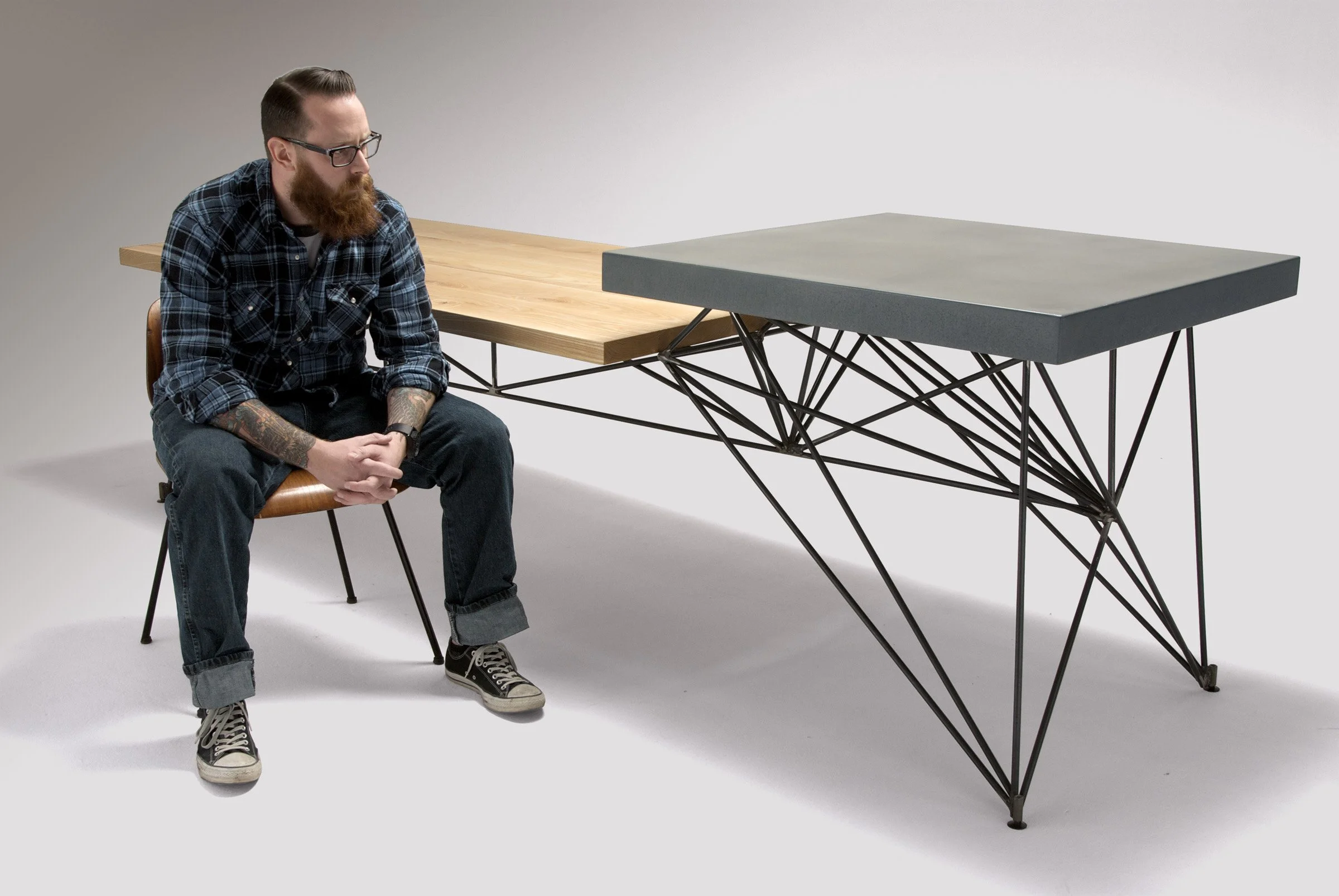 Modern dining table handcrafted in concrete, steel, and wood. Designed to be multifunctional furniture - dining, office, and kitchen prep in one timeless piece.
