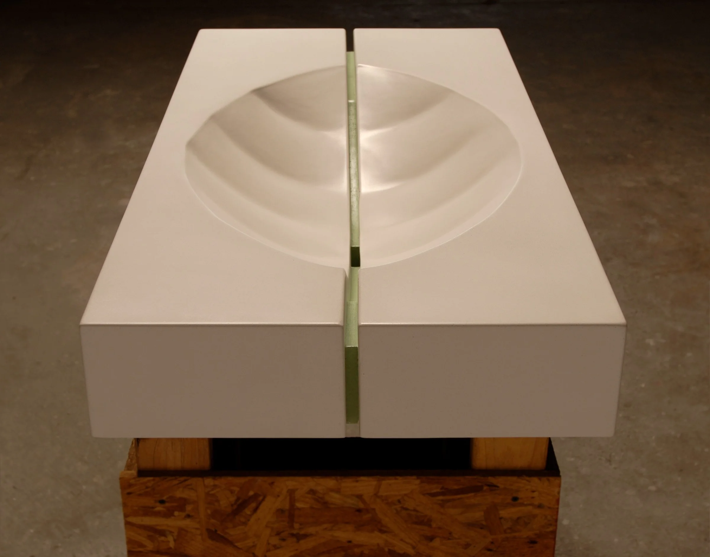 Early artisan concrete sink handcrafted in 2006 with bold design details.