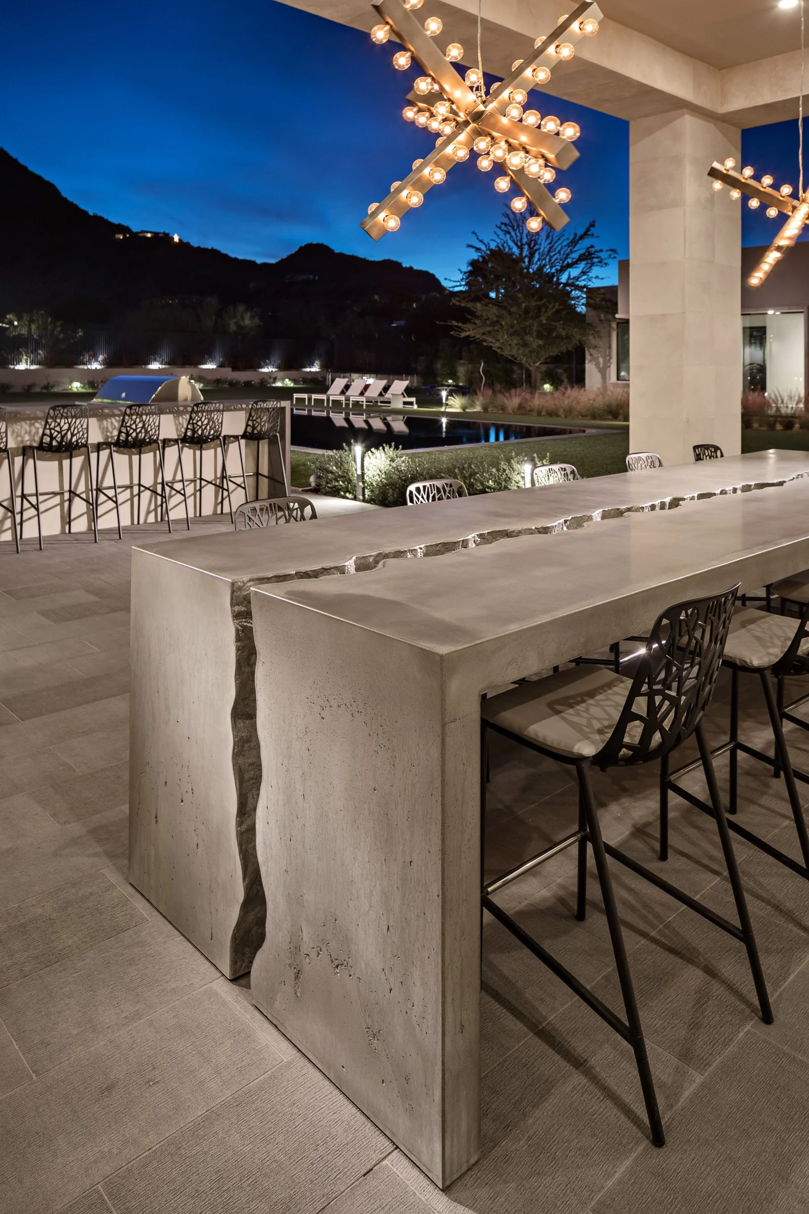Artisan outdoor dining furniture with monumental cracked concrete design