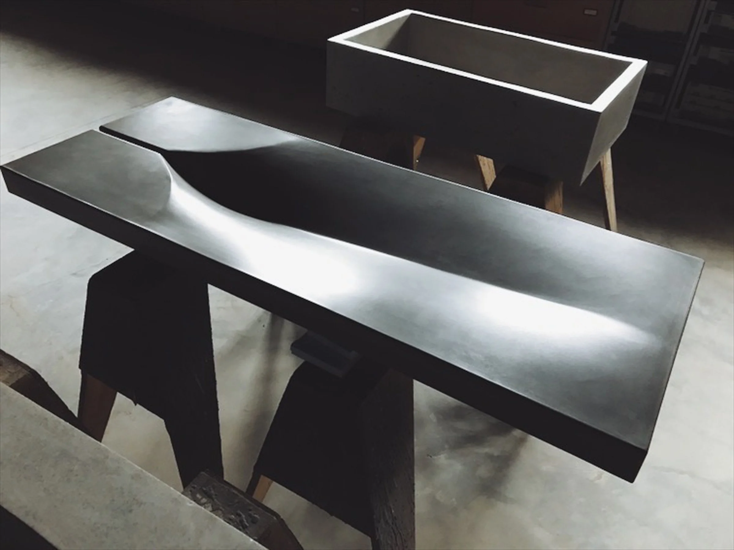 Handcrafted concrete sink designed in a workshop to resemble a leaf. Built from crystalline silica-free GFRC and finished with a high-performance food-safe sealer.