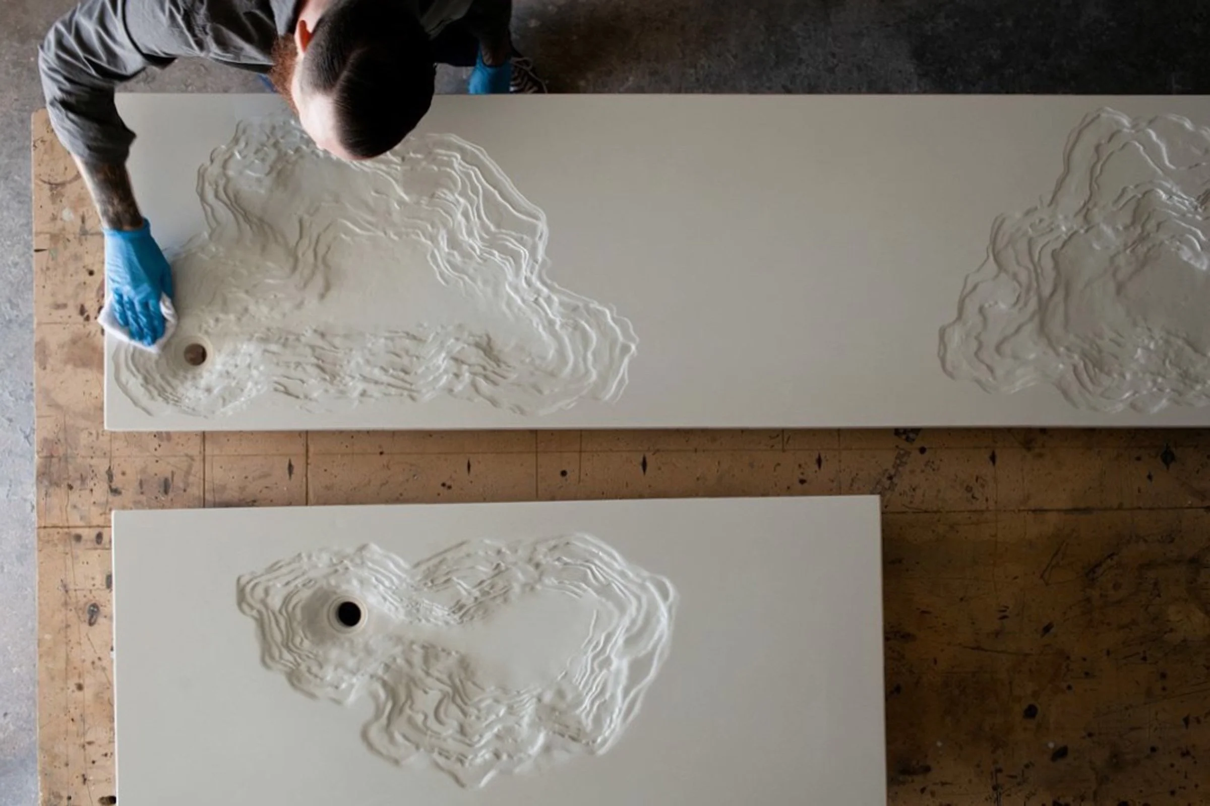 Brandon Gore working on crafting 2 custom white concrete Erosion Sinks.