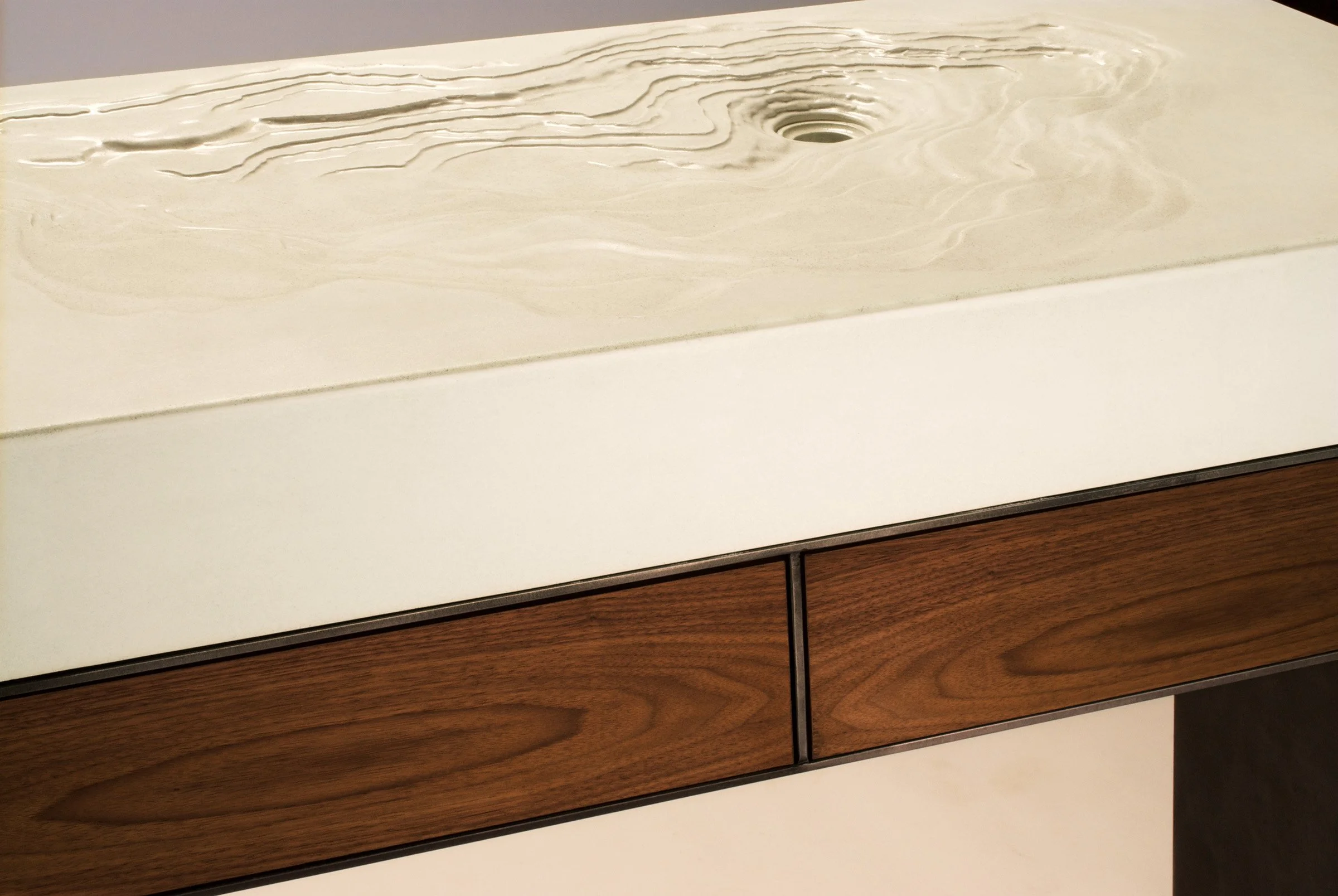 Custom erosion-style concrete sink showcased at Dwell on Design trade show.